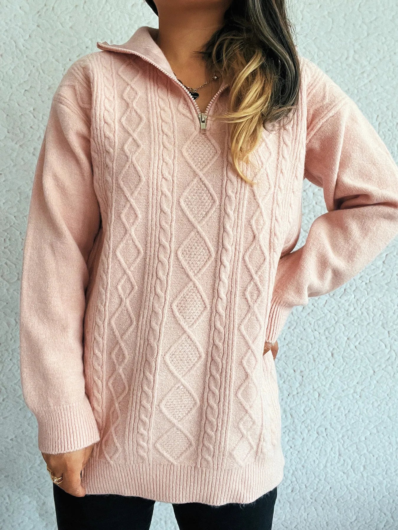 Close-up of the Cozy Cable-Knit Texture Zip Collar Long Sleeve Sweater, emphasizing the soft pink hue and textured knit, ideal for stylish comfort.