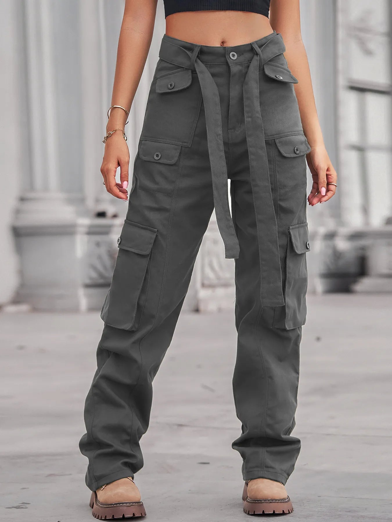 Fashionable high-waisted multi-pocket cargo jeans showcasing front pockets and a stylish tie belt for a polished appearance.