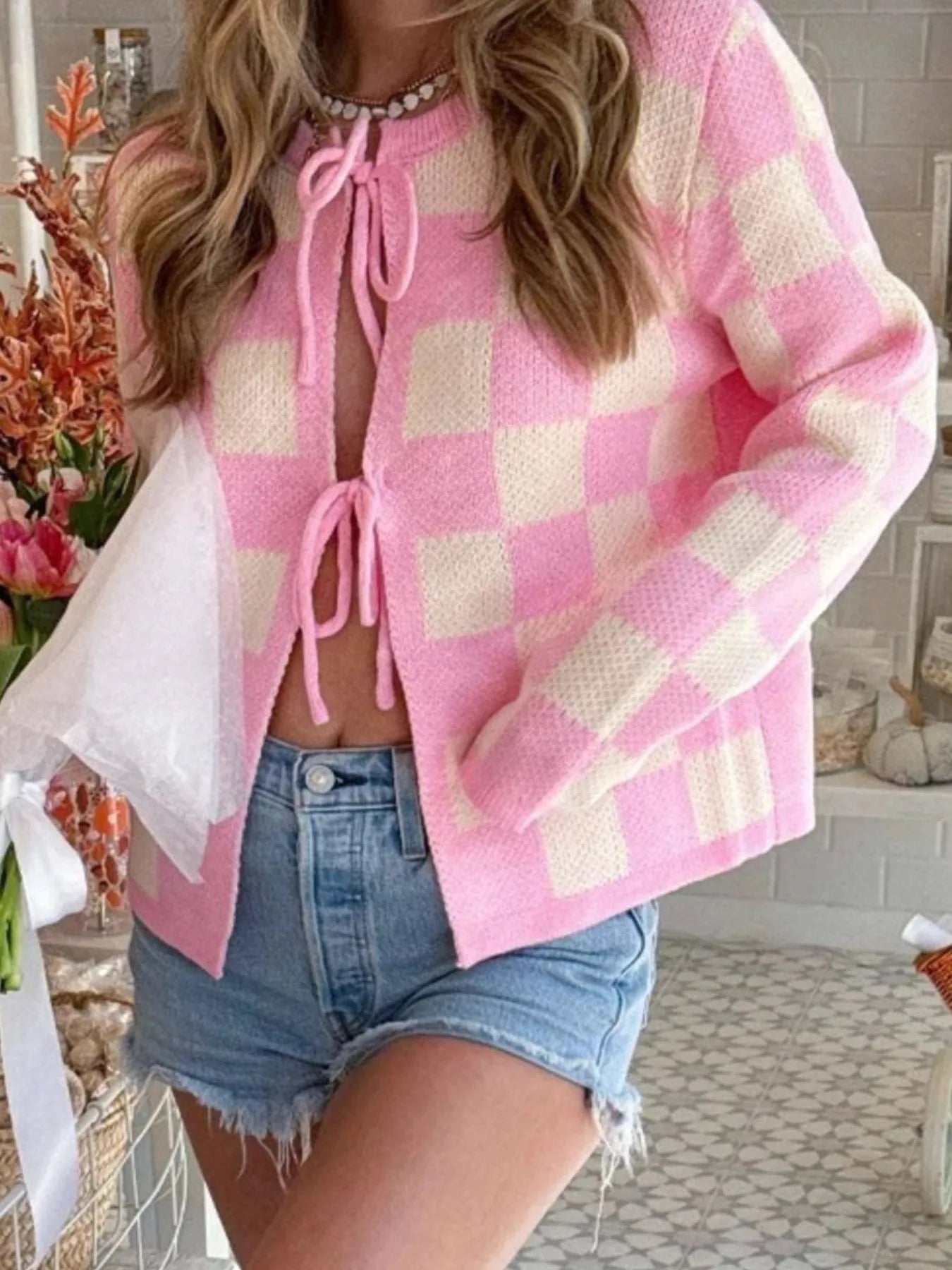 Checkered Tie-Front Cropped Cardigan for Women - Slightly Stretchy, 100% Polyester Fabric, worn with denim shorts, emphasizing a chic pink checkered style.