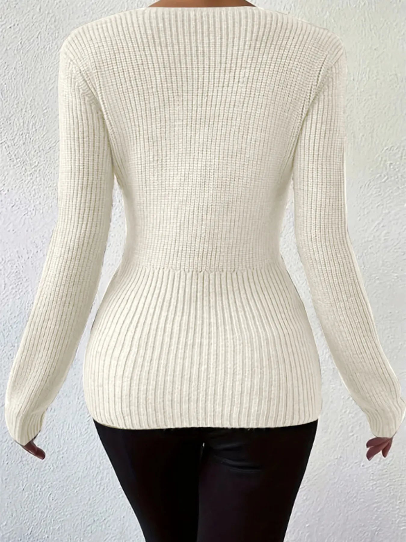Back view of the Sleek Ribbed V-Neck Knit Top with Twist Front Detail in white, showcasing the slim ribbed fit that accentuates curves.