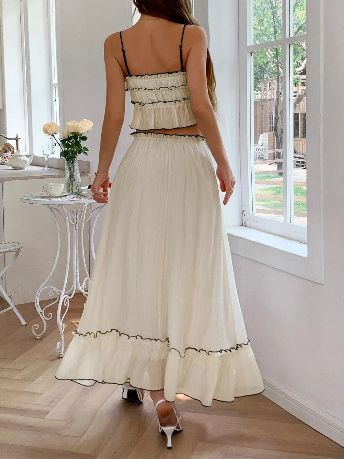 Back view of a model wearing the Two-Piece Frill Square Neck Cami and Ruched Skirt Set in Stretchy Lyocell Blend, showcasing its elegant frill details and flowy skirt.
