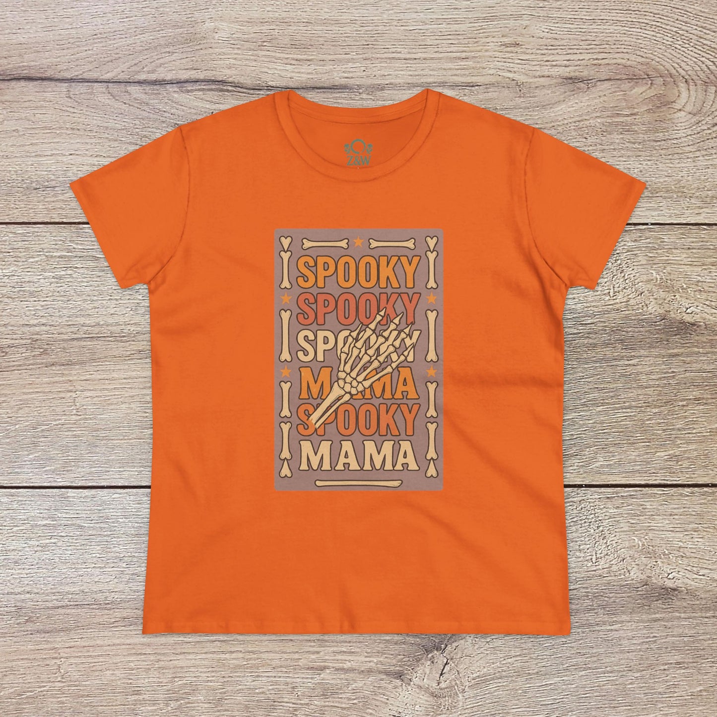 Spooky Mama Tee in orange - Soft and comfortable cotton fabric with a vibrant Halloween design stating 'Spooky Mama'. Great for celebrating the spooky season.