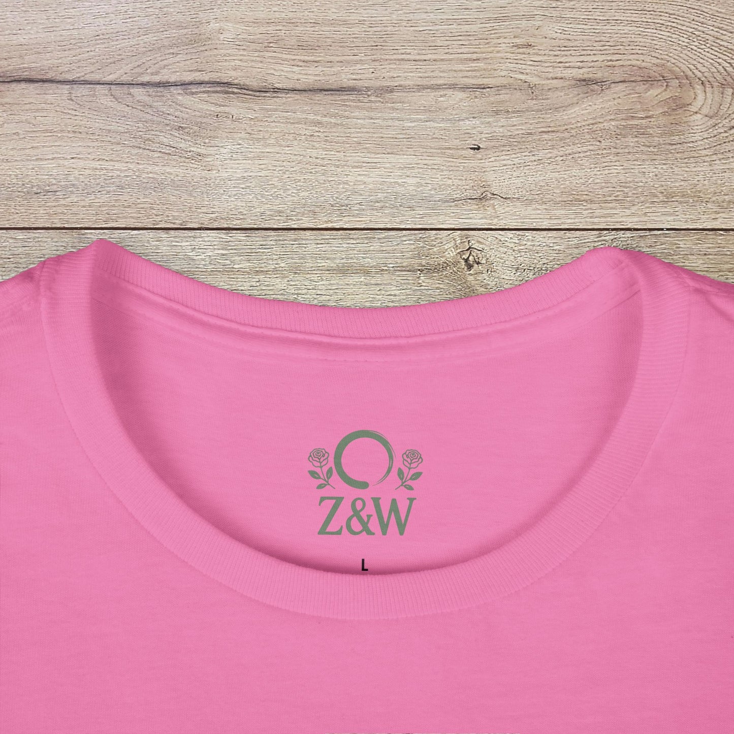 Close-up of the Under-Caffeinated Over-Stimulated Hoodie in pink, featuring a detailed view of the embroidered logo and soft neck opening.