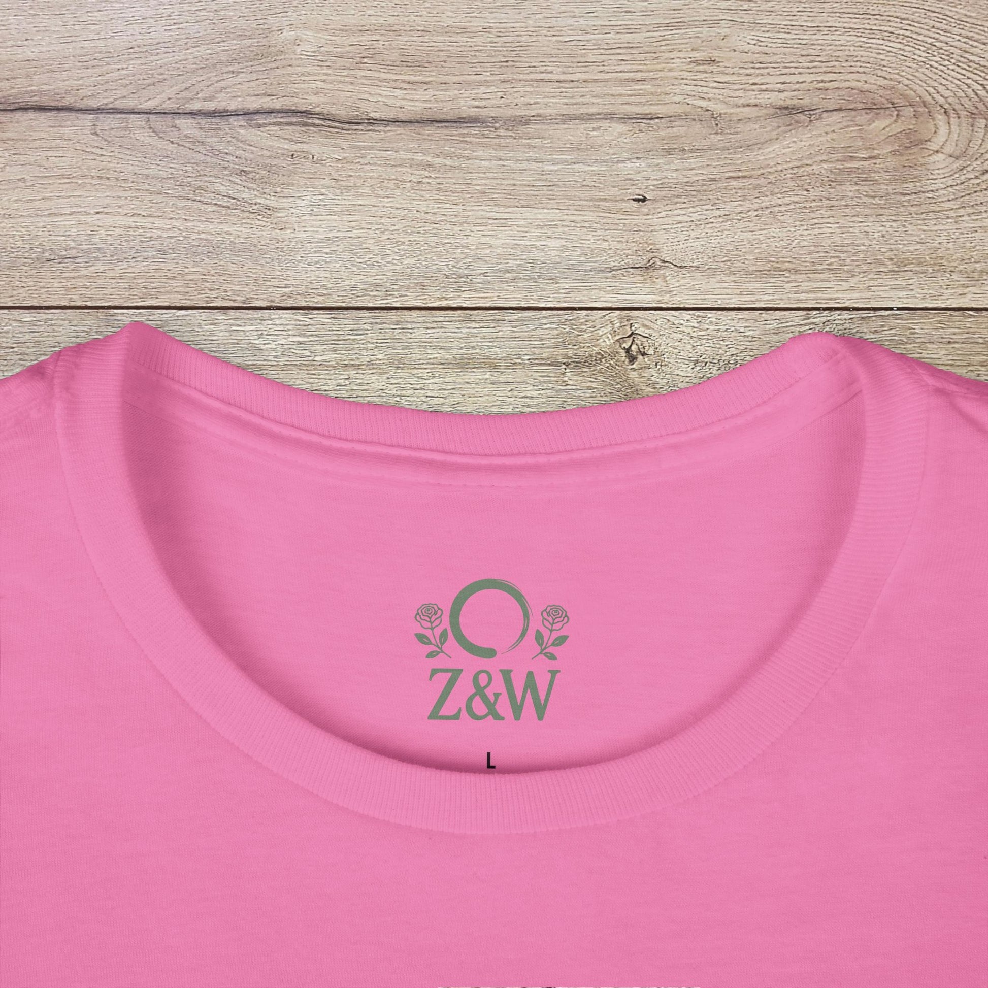 Close-up of the Under-Caffeinated Over-Stimulated Hoodie in pink, featuring a detailed view of the embroidered logo and soft neck opening.