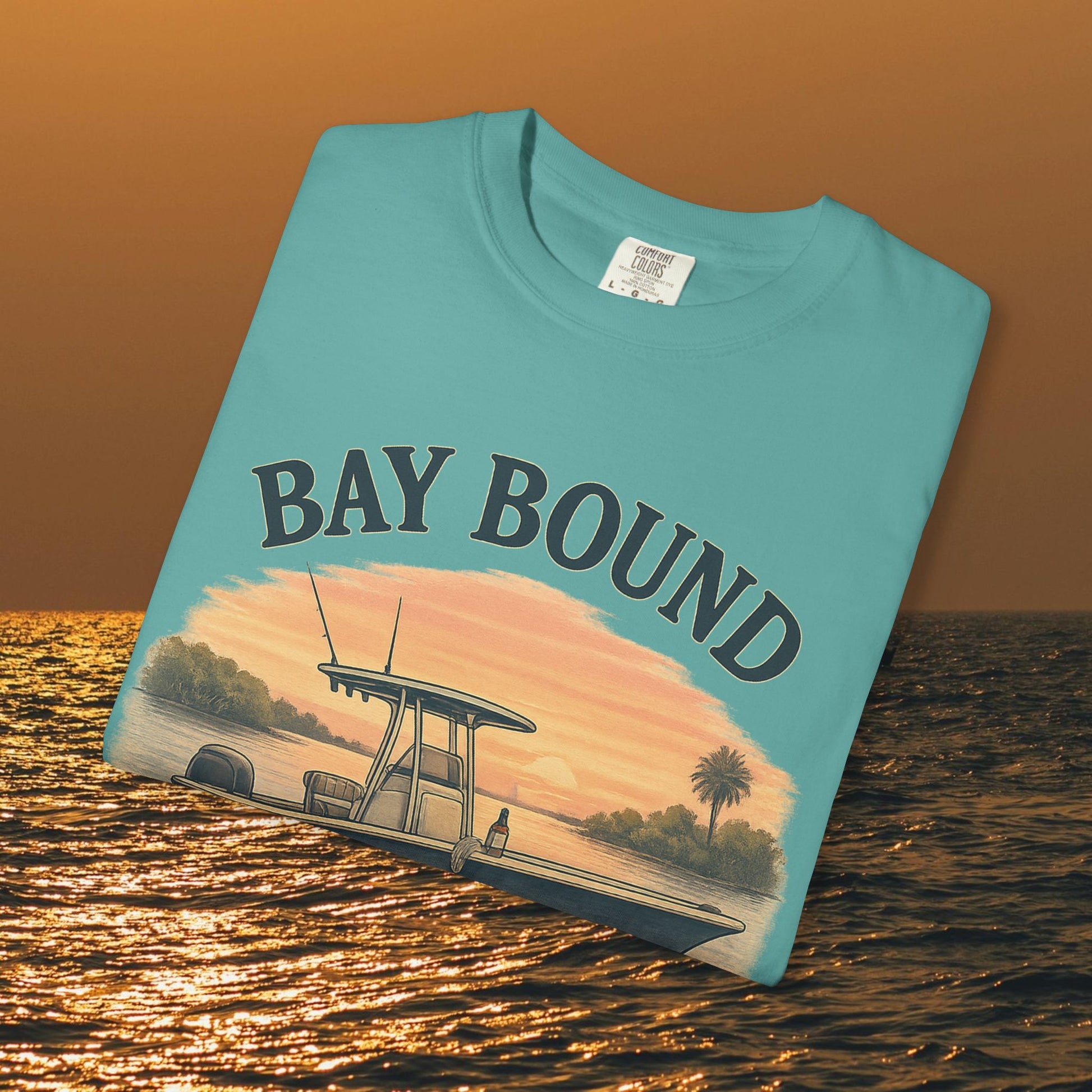 Close-up of a Bay Bound boating t-shirt displayed flat, showcasing vibrant colors and a boat design, perfect for fishing and beach lovers.