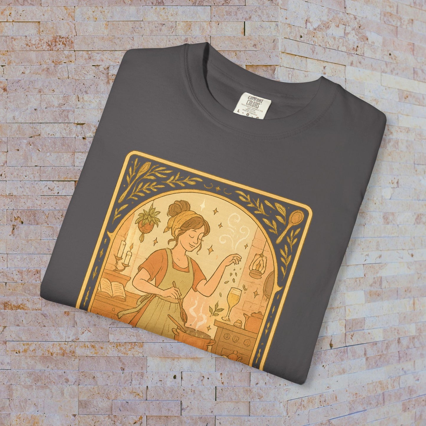 Folded Culinary Queen Tarot Tee in dark gray, featuring an enchanting design of a woman in a kitchen setting, designed for comfort and durability, available in sizes S to 4XL.