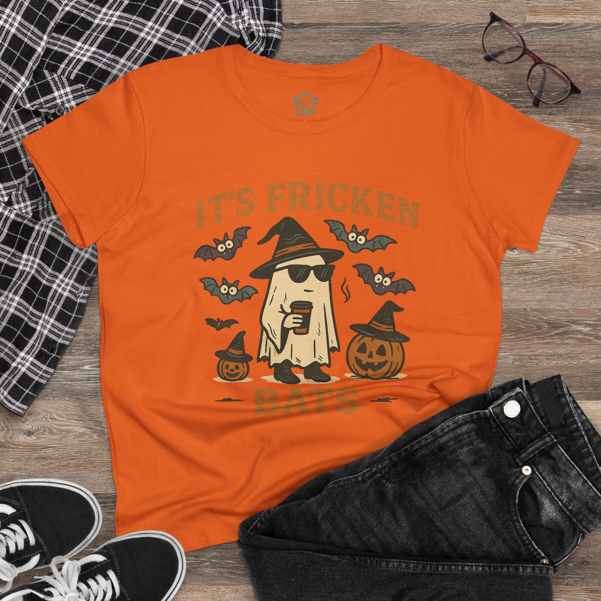 Stylish Halloween Unisex T-Shirt, orange with a fun graphic design, perfect for trick-or-treating, shown with casual outfit.