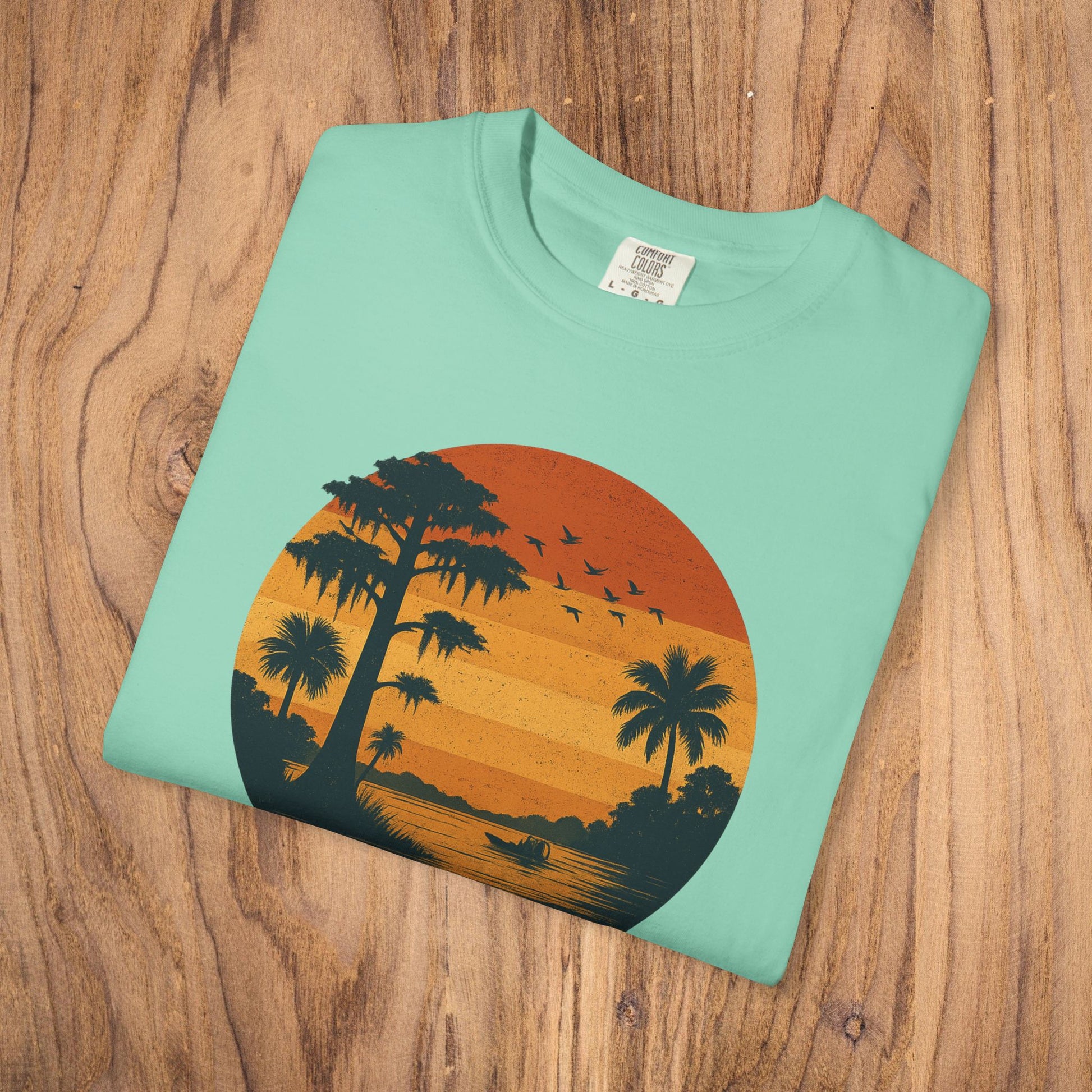 Unisex Garment-Dyed Sunset Tee - Soft 100% Cotton T-Shirt in aqua blue, featuring a serene sunset graphic with palm trees, perfect for laid-back gatherings.