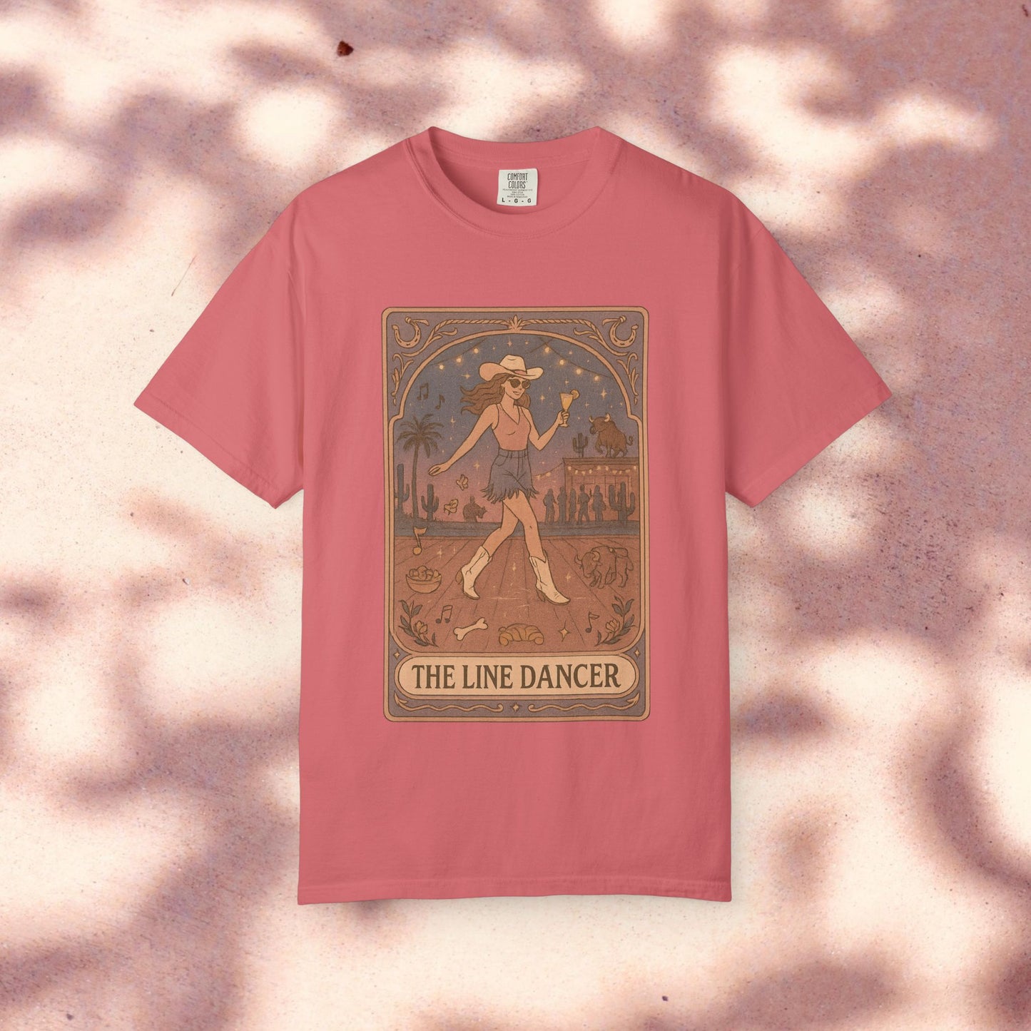 Line Dancer Tarot Tee in soft pink, featuring a unique design of a dancer with a vibrant background, made from ethically sourced cotton. Available in sizes S-4XL.
