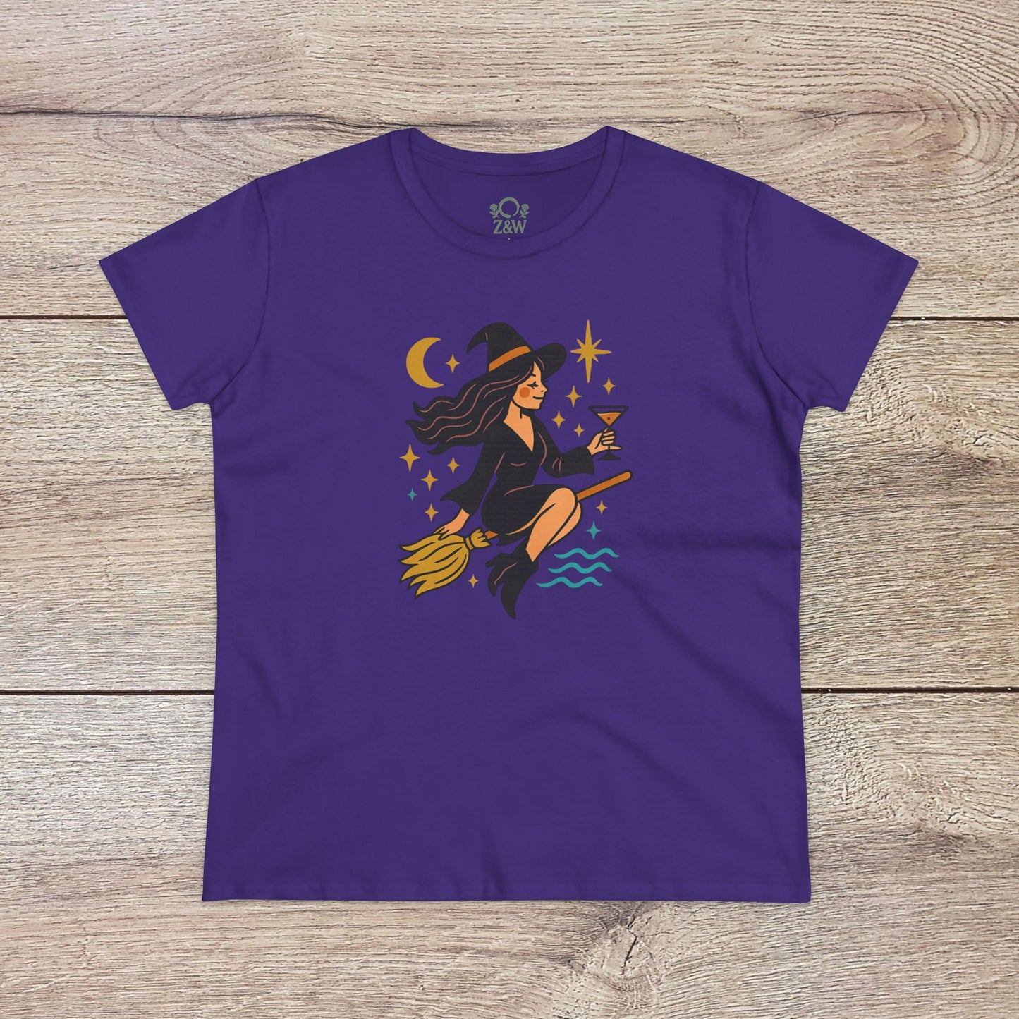 Witchy Night Out Tee in deep purple featuring a charming witch in flight, complete with cosmic accents, crafted from ethically made, 100% ring-spun cotton for a stylish fit.