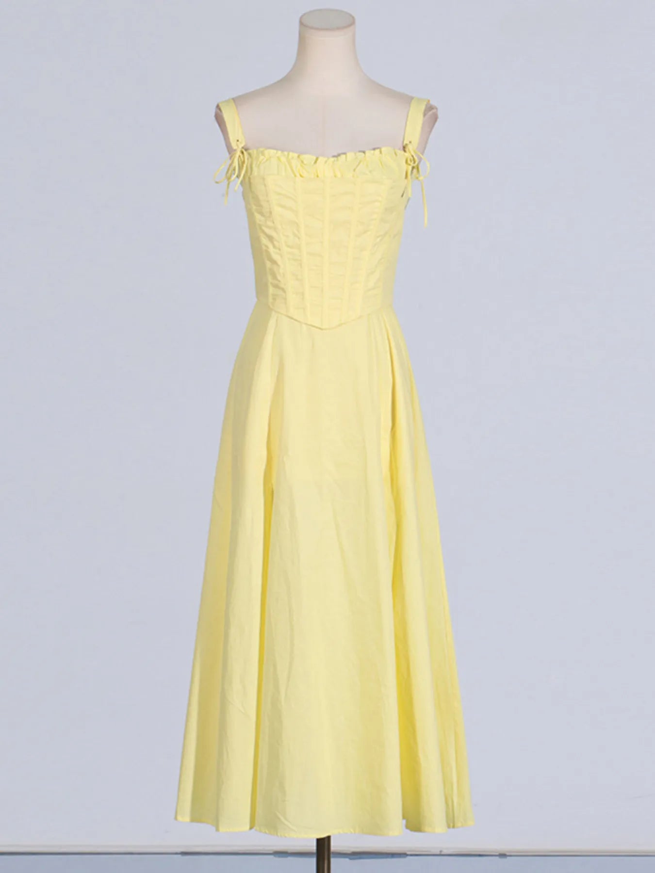 Front display of the Trendy Slit Sleeveless Midi Dress with Zip Back in yellow on a mannequin, emphasizing its frill detail and sophisticated silhouette.