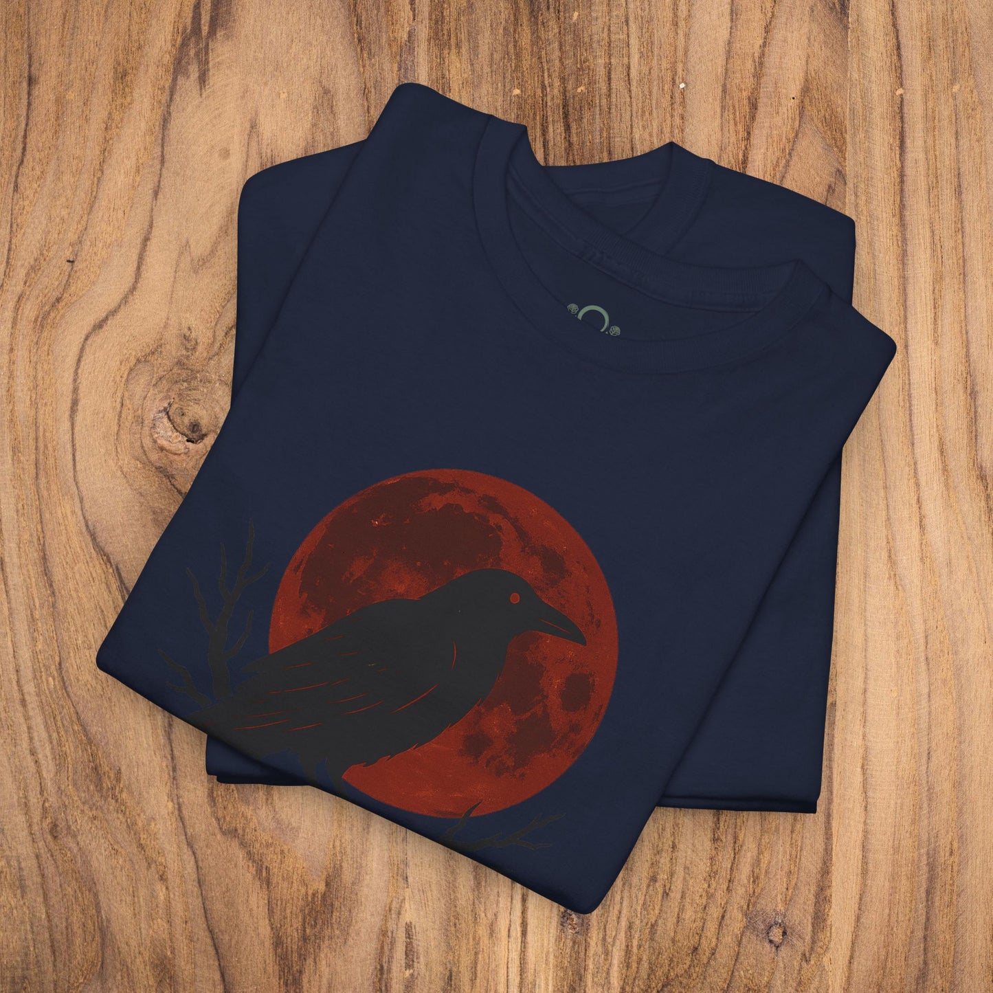 Gothic Raven T-Shirt emphasizing a raven silhouette in front of a red moon, a great choice for Halloween. Made from heavy cotton, this unique spooky gift complements any casual fall wardrobe.