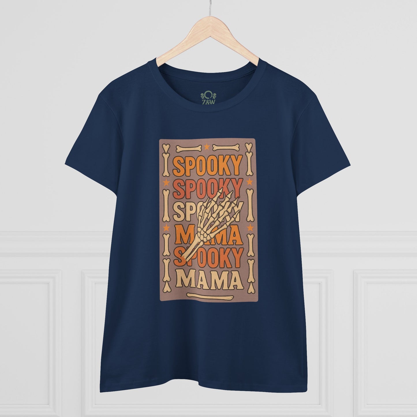 Front view of the Spooky Mama Tee in navy blue displayed on a hanger, highlighting its spooky print design that captures Halloween spirit and casual style.