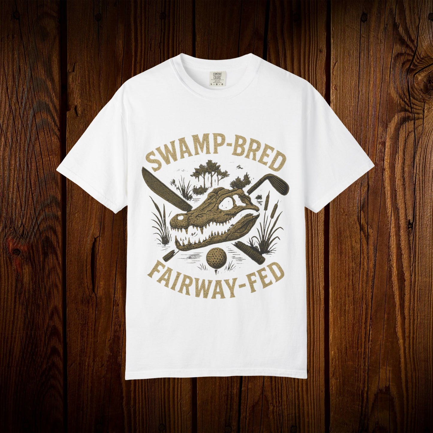 Unisex Swamp-Bred Fairway-Fed Tee in white, featuring an artistic alligator design with golf clubs, perfect for casual wear.