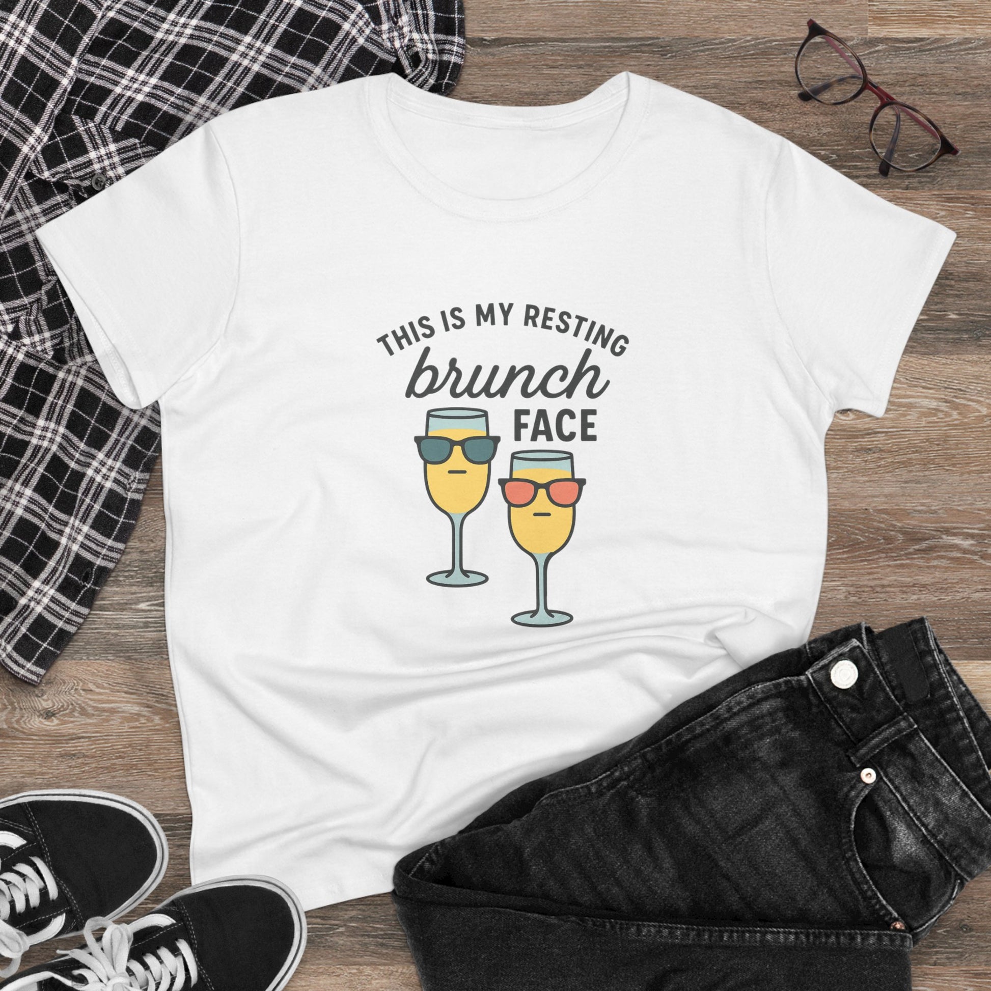 Close-up of Women's Premium 100% Cotton Brunch Face Tee - Comfortable, Durable & Stylish laid flat on a wooden surface, showing the fun brunch graphic and casual style.