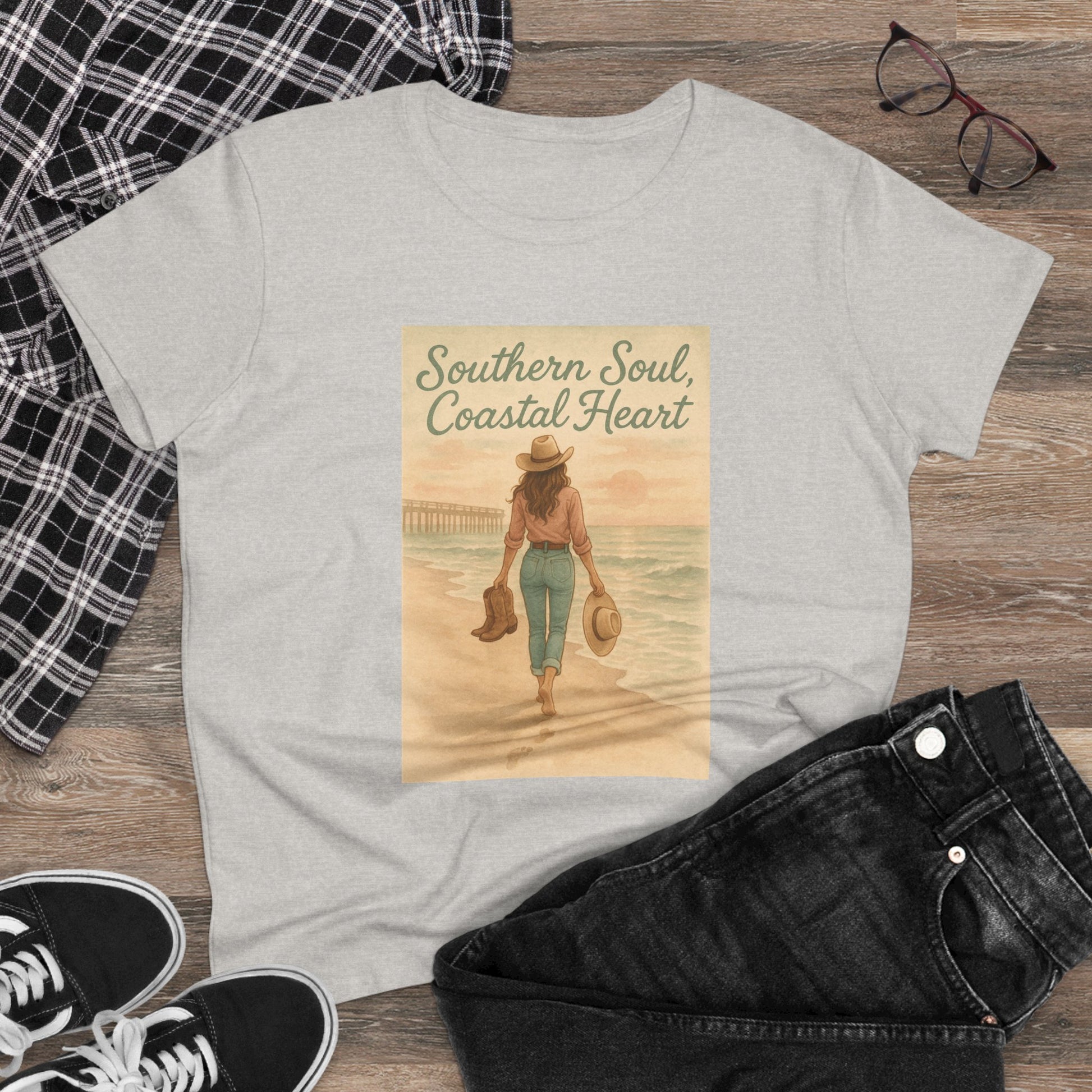 Flat lay of Southern Soul Coated Heart Tee, styled casually with jeans and sneakers, highlighting the artistic beach design and soft fabric, designed for versatility in unisex sizes S-3XL.