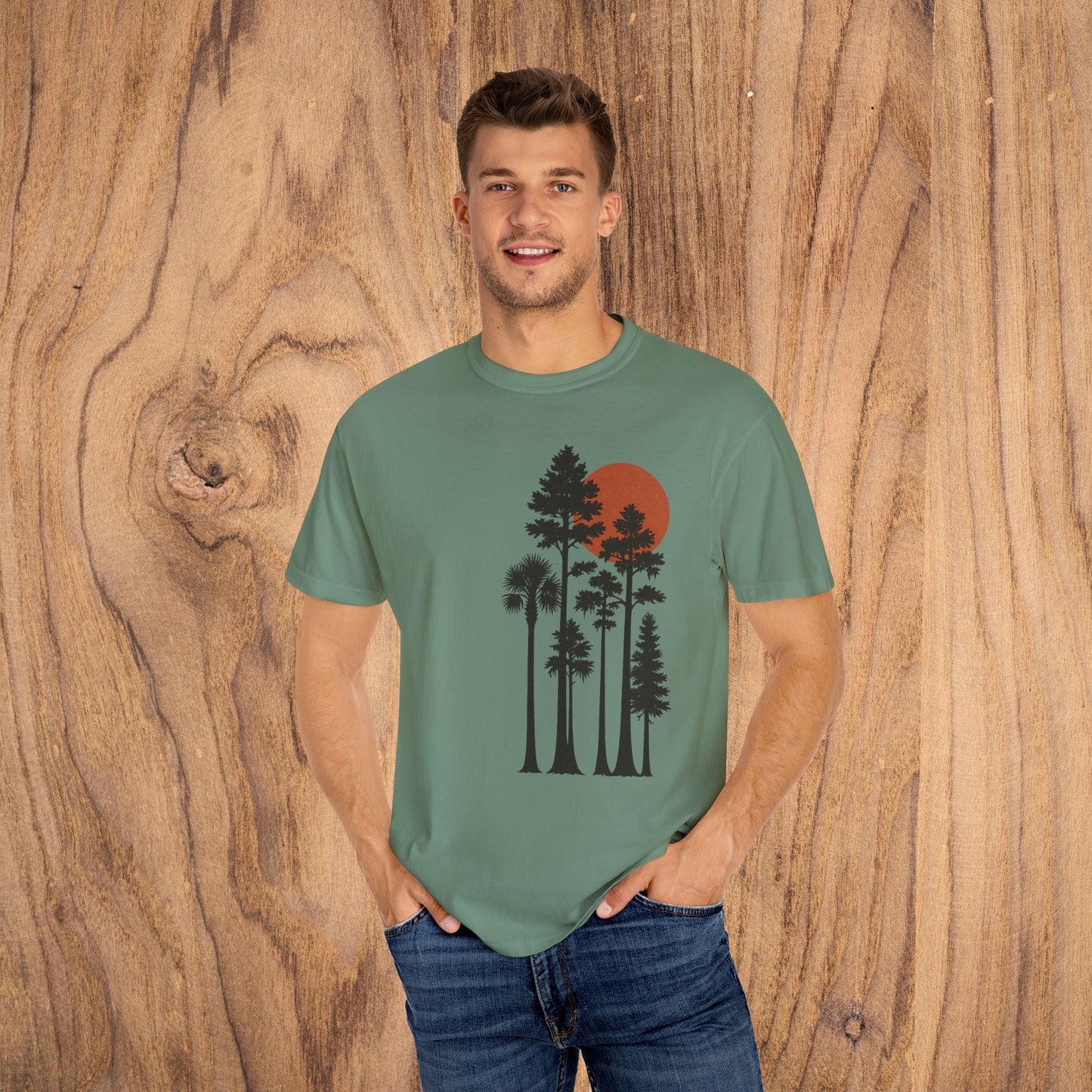 Model wearing Sunset Trees Unisex T-Shirt in green color, showcasing the unique design featuring sunset and trees, ideal for outdoor lovers.