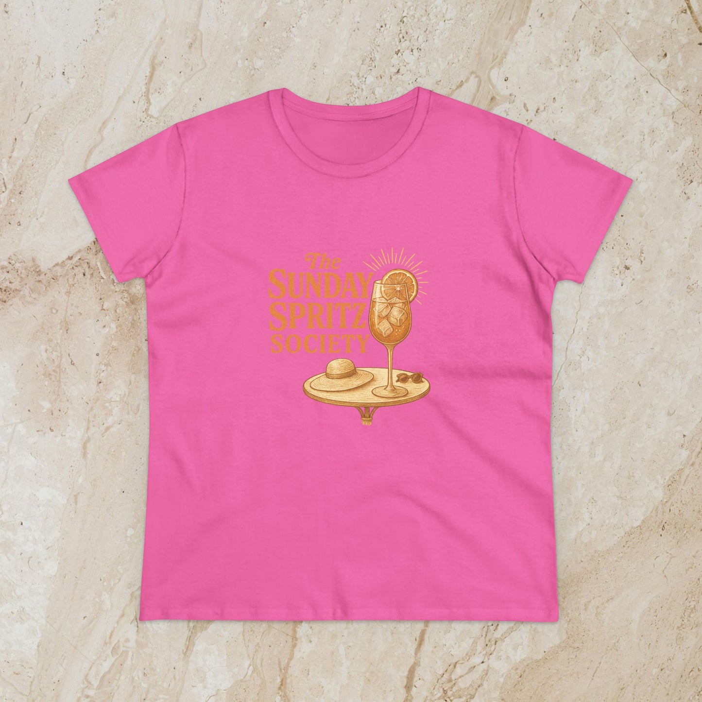 Light pink Women's Midweight Cotton Tee showcasing 'The Sunday Spritz Society' print, a stylish choice for relaxed days and social gatherings.