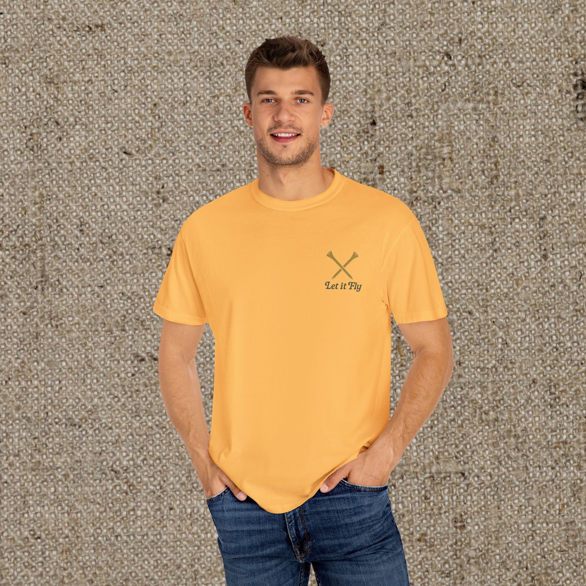 Man wearing the Tee It High Let It Fly Graphic Tee in yellow, posing casually with hands in pockets, emphasizing the comfortable fit and stylish design.