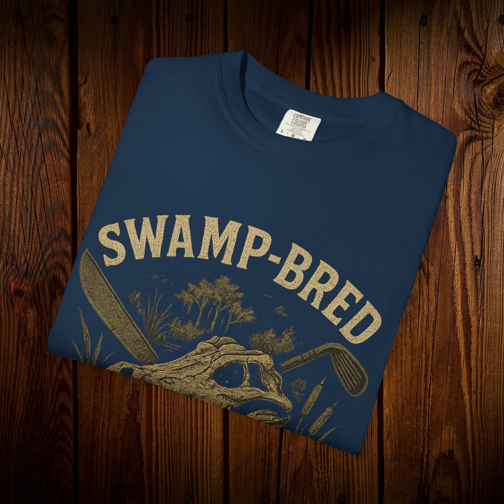 Front view of the Unisex Swamp-Bred Fairway-Fed Tee displaying a unique swamp-themed graphic, ideal for golf enthusiasts.