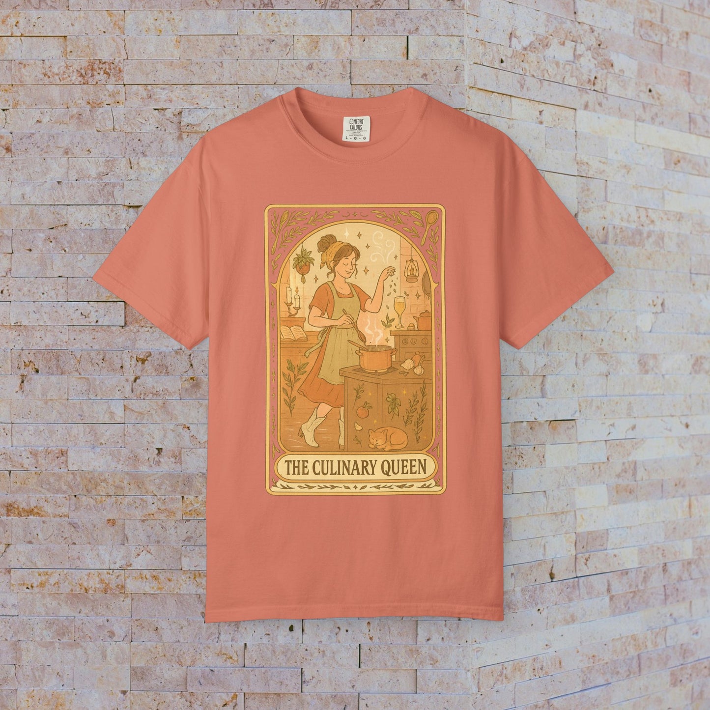 Culinary Queen Tarot Tee in coral, showcasing a charming illustration of a queen with a goose in the kitchen, offered in sizes S to 4XL, crafted from soft, pre-shrunk cotton.