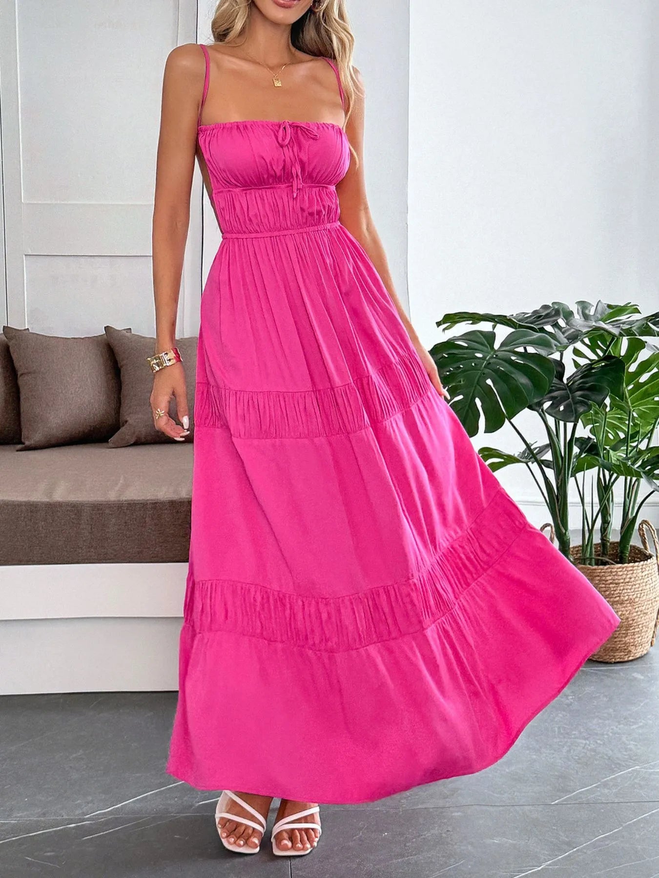 Model wearing the Tied Back Tiered Maxi Cami Dress in pink, featuring a fitted bodice and elegant tiering, perfect for summer outings or casual events.