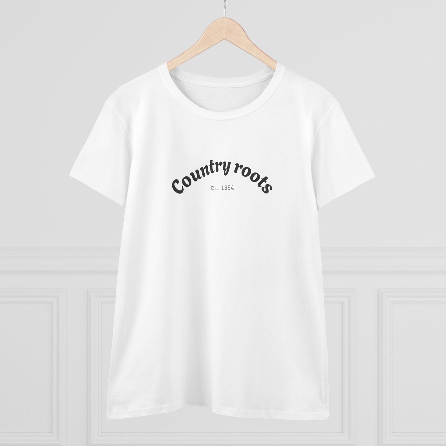 Front view of Country Roots Cowgirl Tee hanging, highlighting the elegant 'Country roots EST. 1994' logo against a clean backdrop.