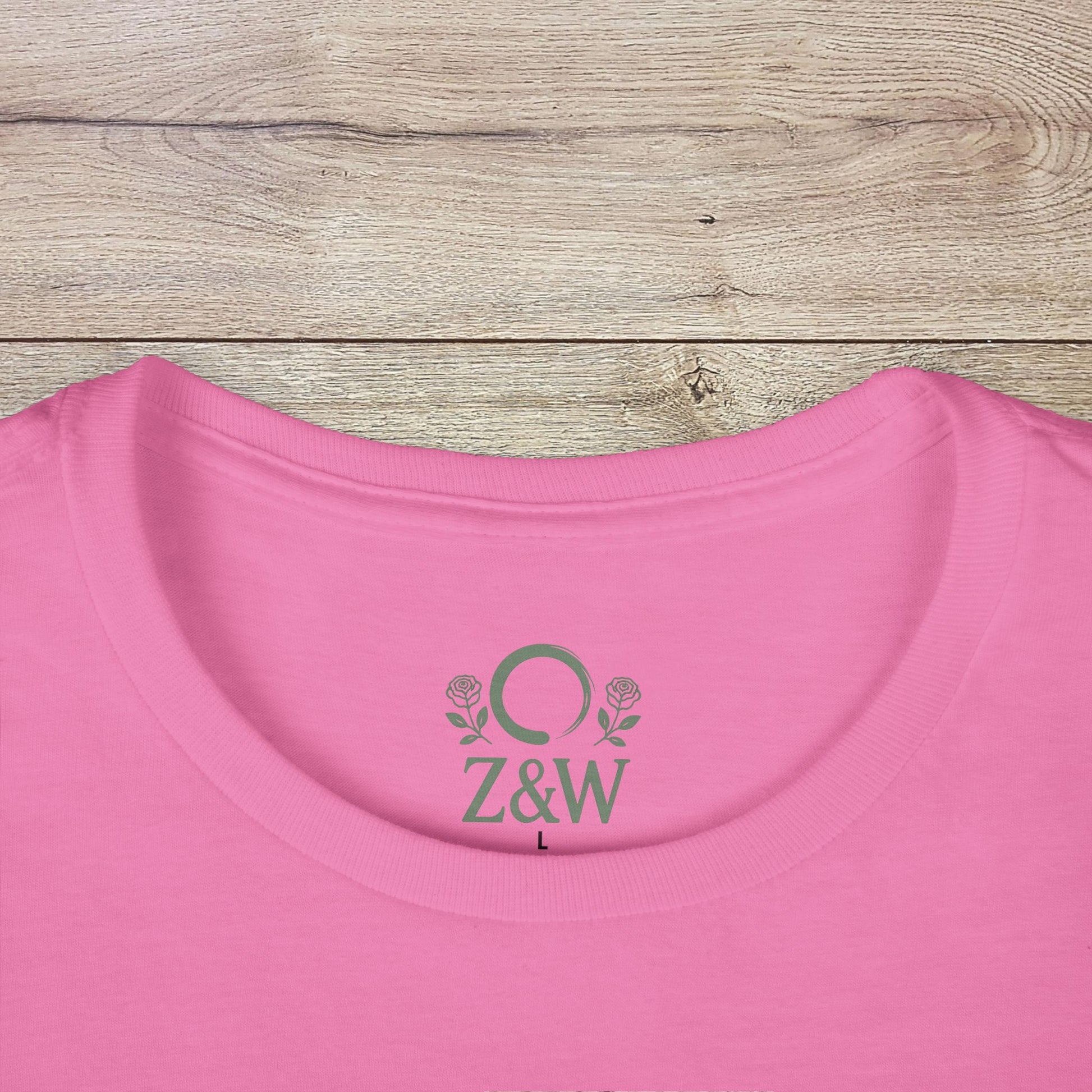 Close-up view of the neckline of the Women's Coastal Spirit Midweight Cotton Tee in pink, featuring the Z&W logo, highlighting the tee's comfortable fit for beach outings.