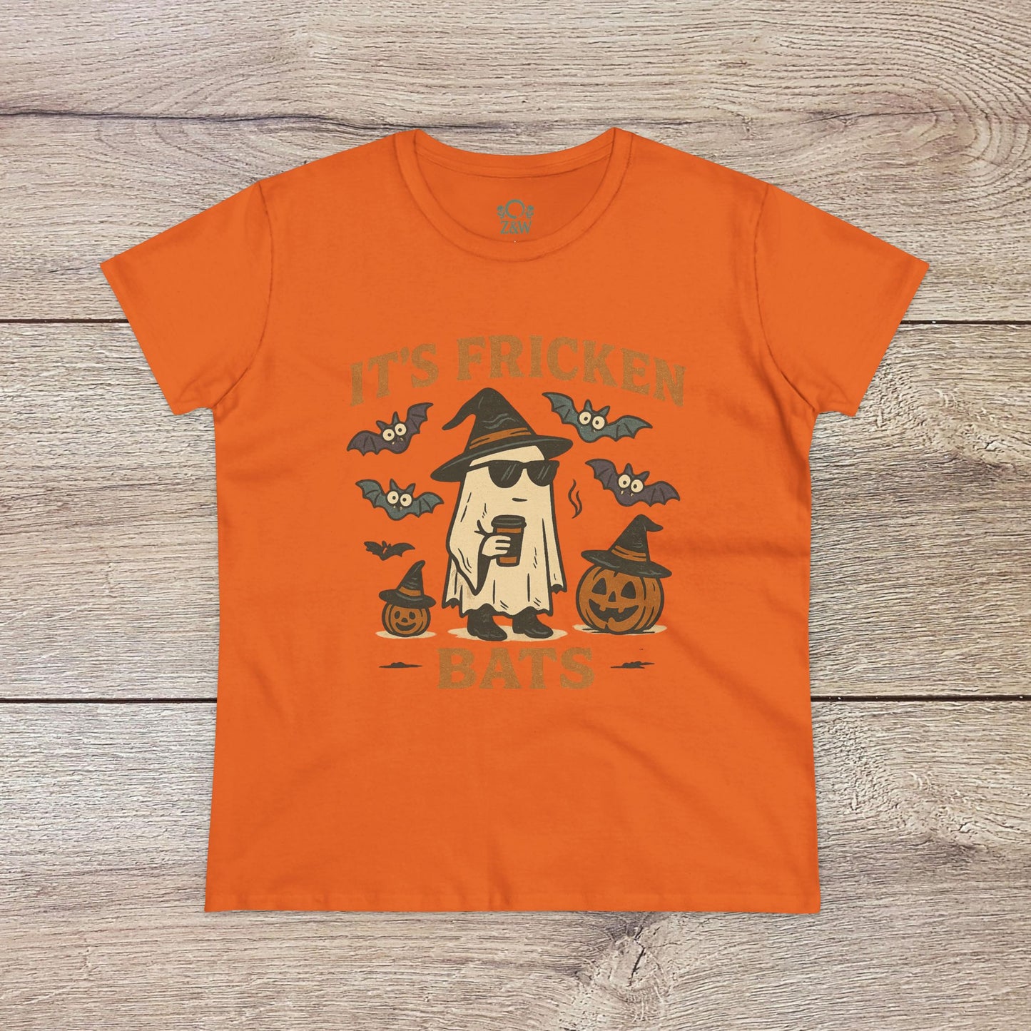 Bright orange Halloween Unisex T-Shirt displaying the humorous text 'It's Fricken Bats' alongside a ghost and pumpkins, made from 100% cotton, ideal for trick-or-treating.