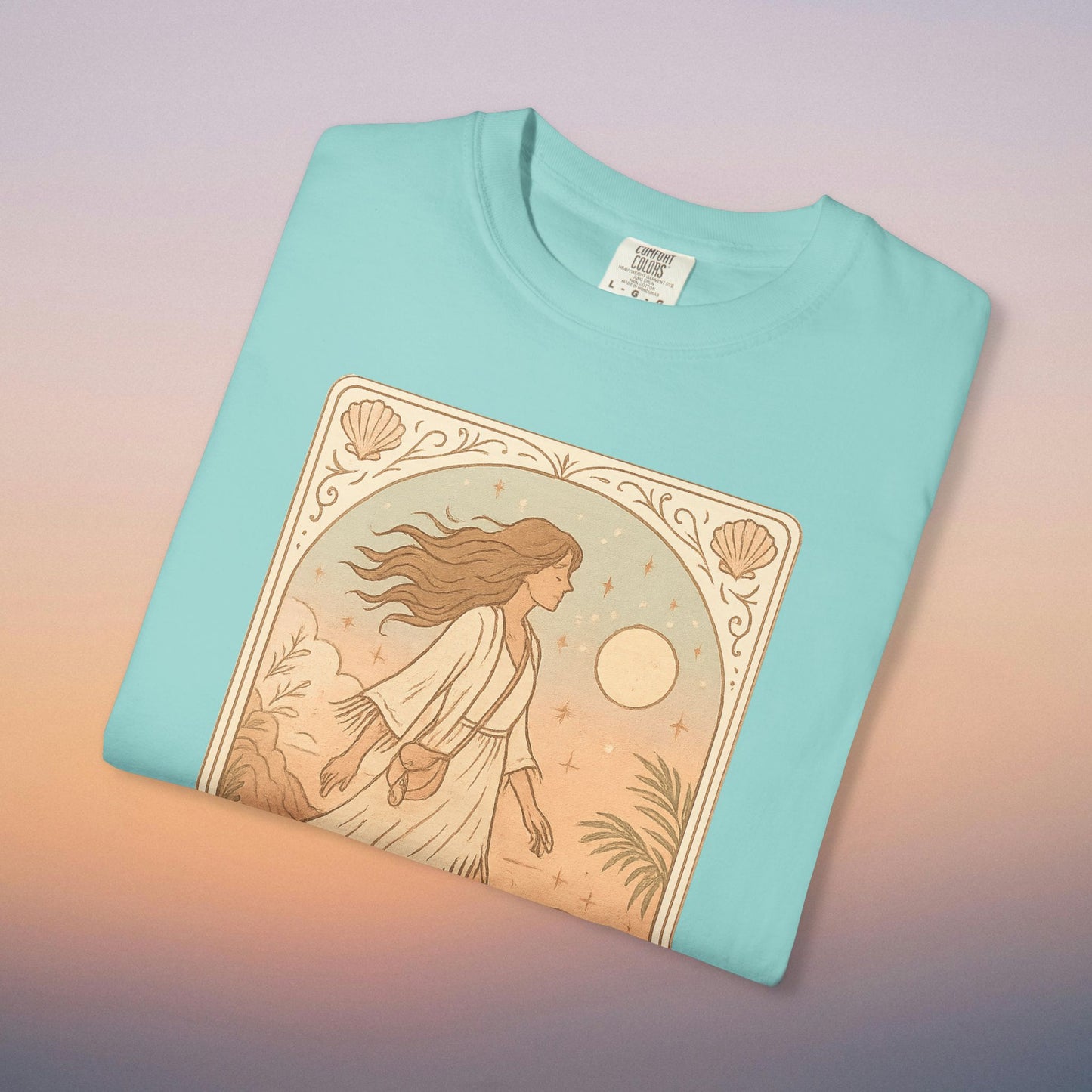 Wanderer Tarot Graphic Tee in vibrant turquoise, displaying a whimsical design of a woman in a serene landscape, perfect for expressing your individuality. Made responsibly from 100% cotton, available in sizes S to 4XL.