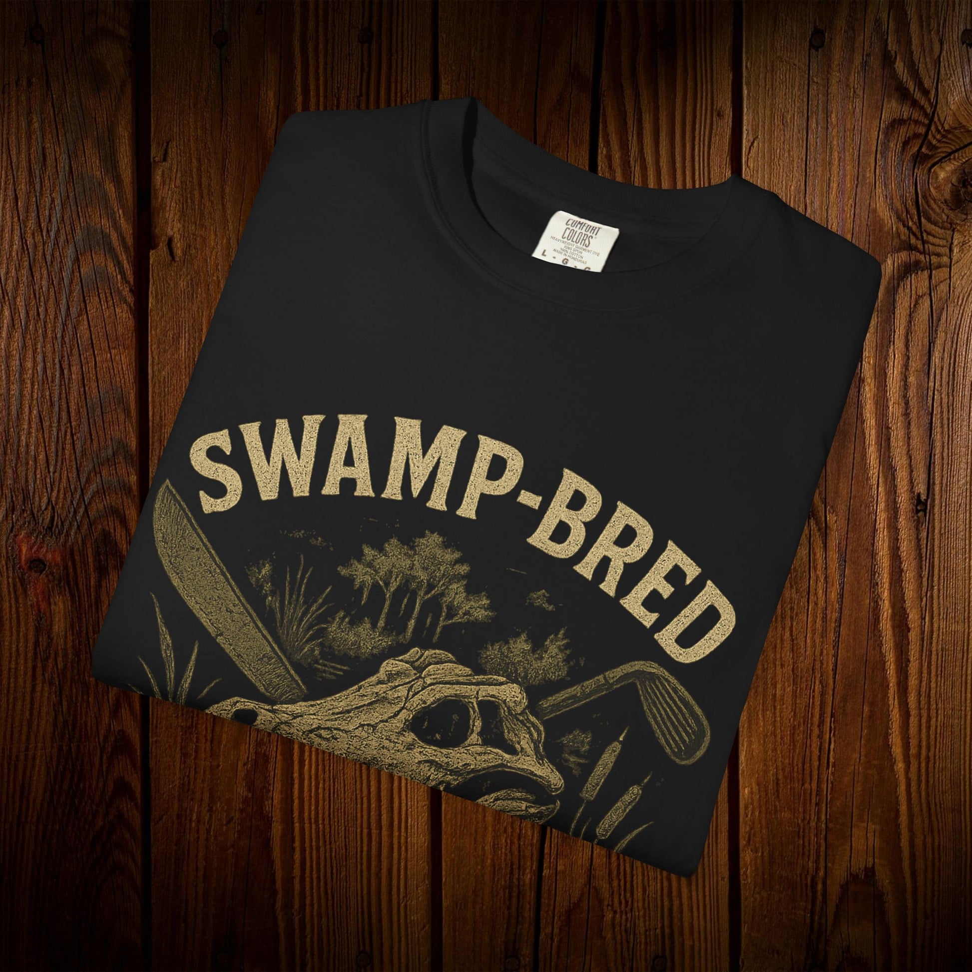 Close-up of the Unisex Swamp-Bred Fairway-Fed Tee with a stylish alligator design, crafted from 100% pre-shrunk US cotton.