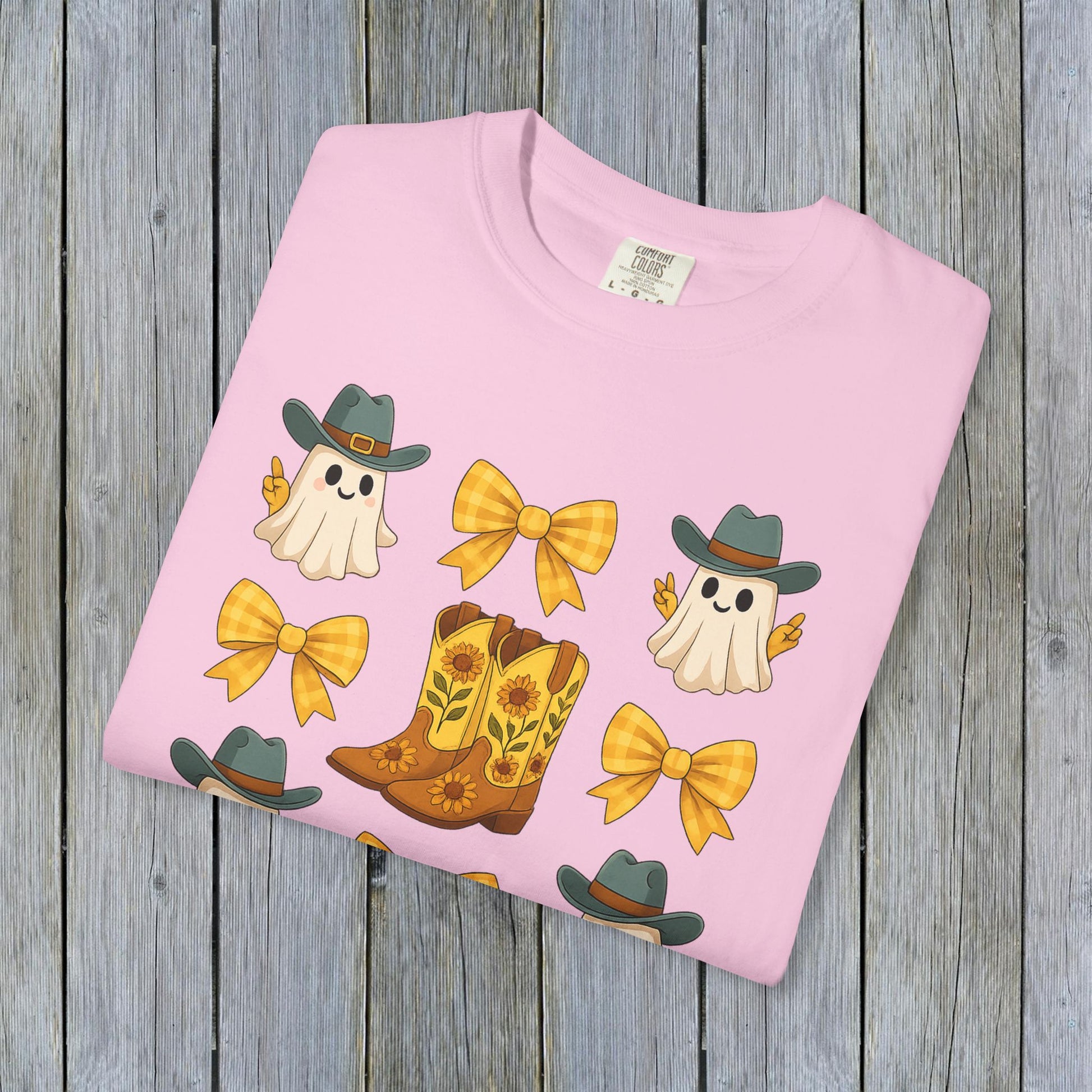 Cute Halloween T-Shirt featuring whimsical ghosts and cowboy boots, perfect for fall fashion, made from eco-friendly fabric.