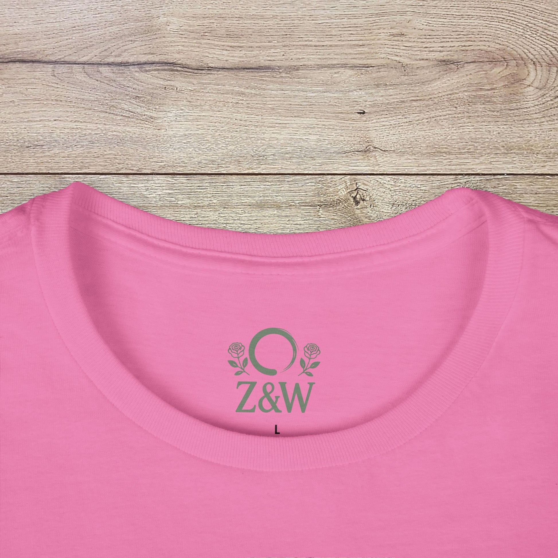 Close-up of the neckline of a pink Halloween Family T-Shirt - Raising Little Monsters Cute Kids Tee for Parties & Costumes featuring a ribbed collar and logo detail.