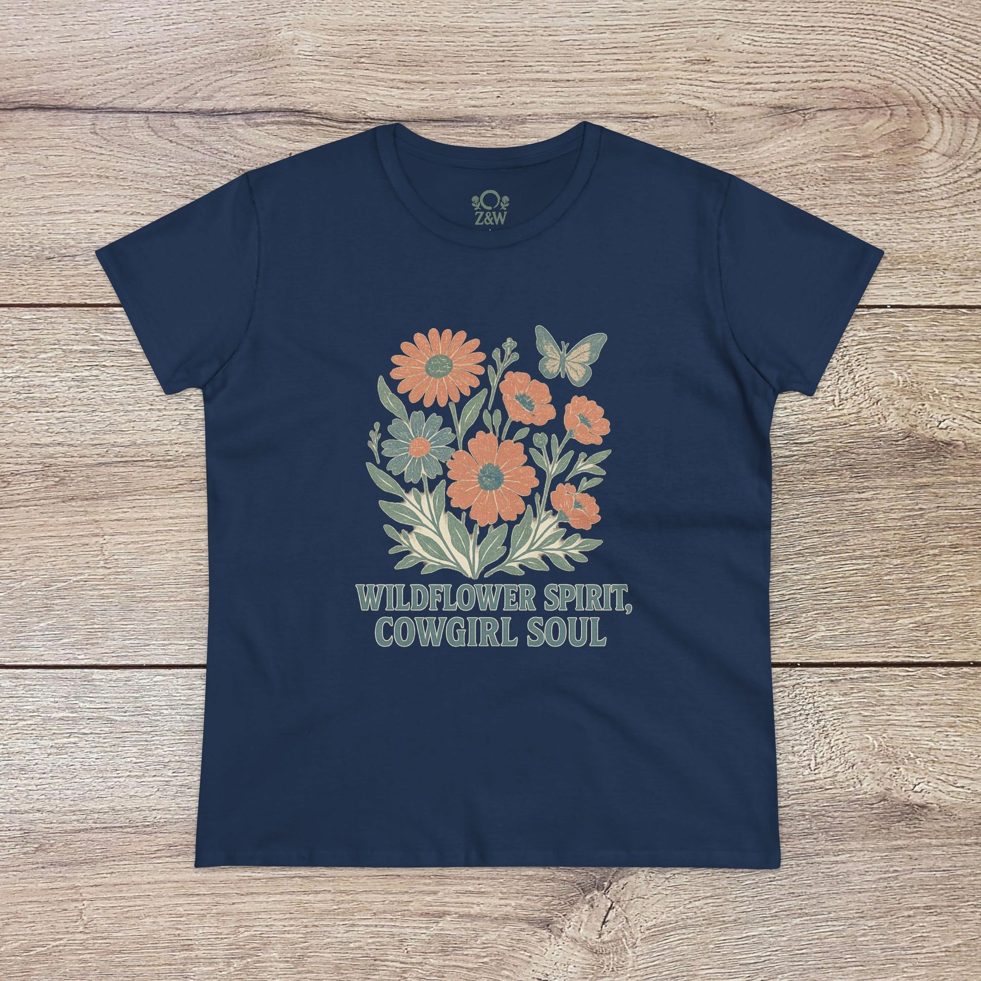 Wildflower Spirit Cotton Tee in navy blue adorned with a colorful floral print and 'Wildflower Spirit, Cowgirl Soul' slogan, ensuring a fashionable look.