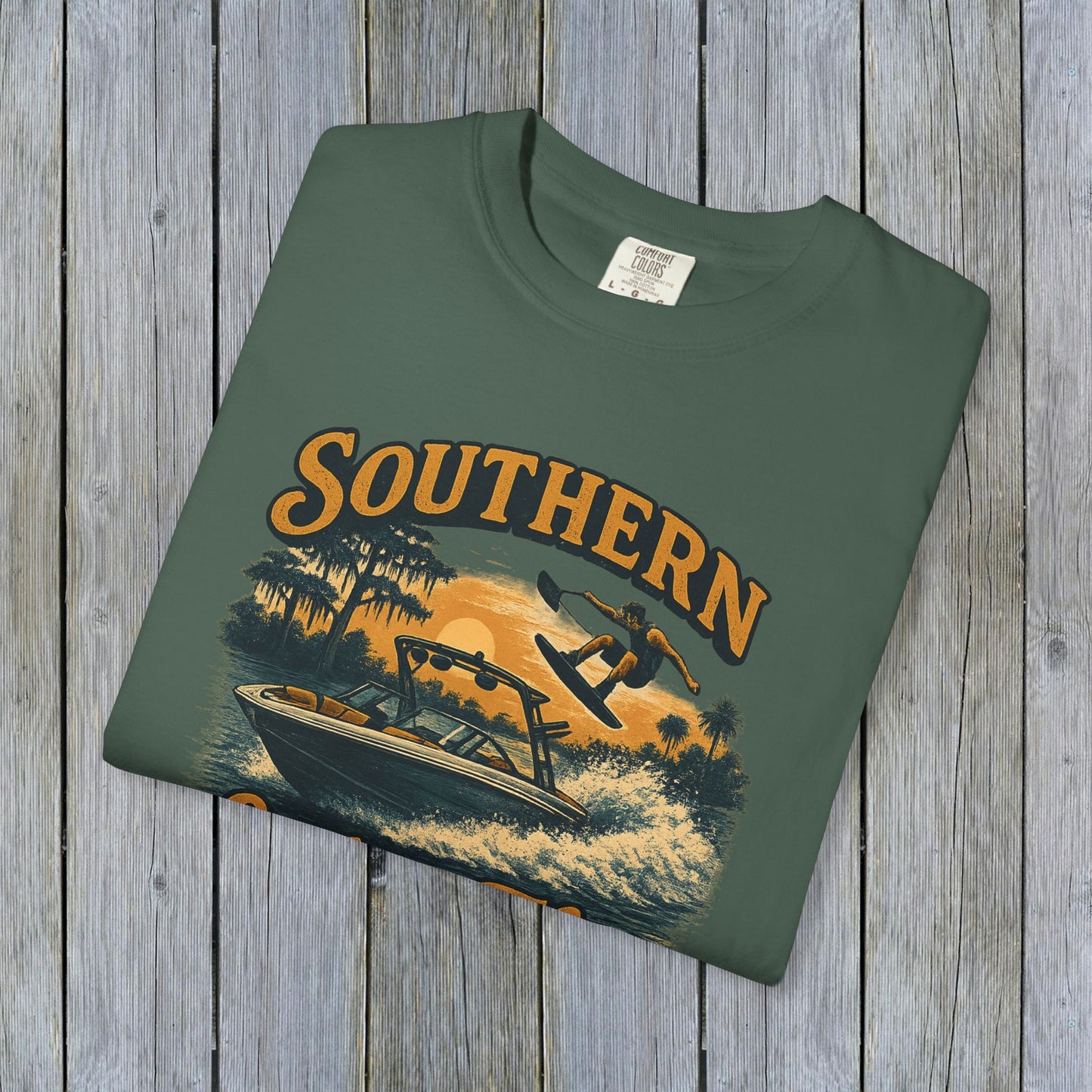 Southern Lake Flow T-Shirt laid flat in olive green, highlighting its unique, eco-friendly design with nautical theme, made of 100% US cotton for comfort.