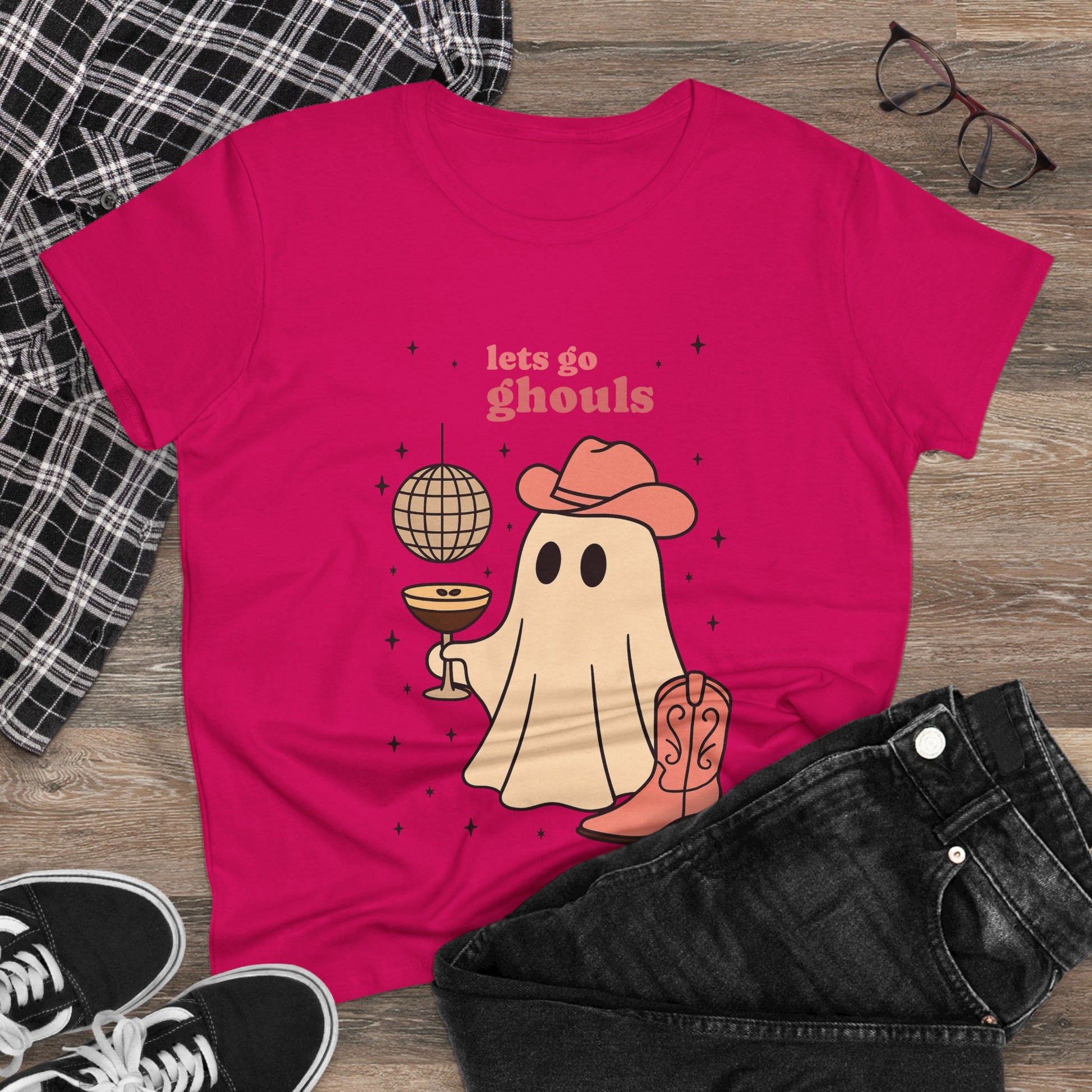Let's Go Ghouls Tee in pink displaying an adorable ghost holding a drink and donning a cowboy hat, perfect for a spooky yet stylish look.