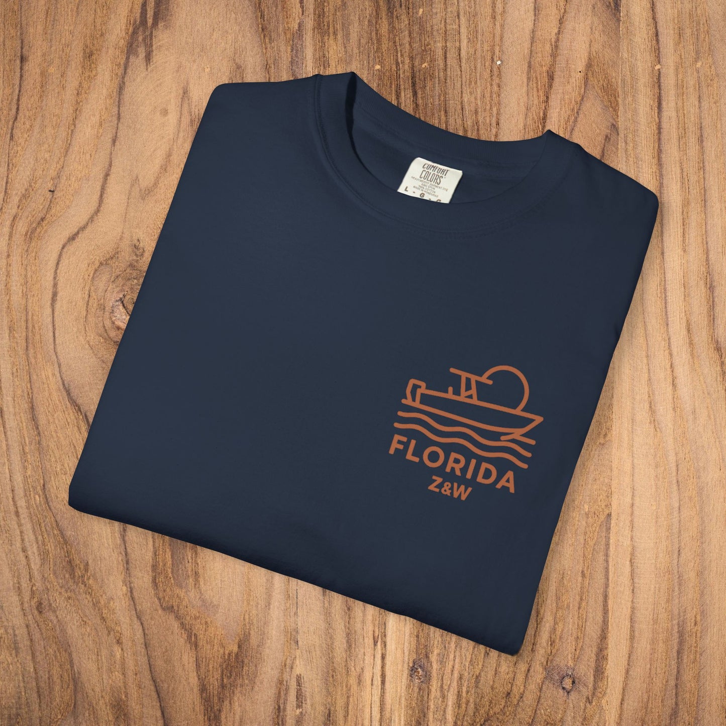 Folded Unisex Florida Graphic Tee showcasing a stylish boat design, made from soft US cotton and garment-dyed for added comfort, ideal for casual outings.