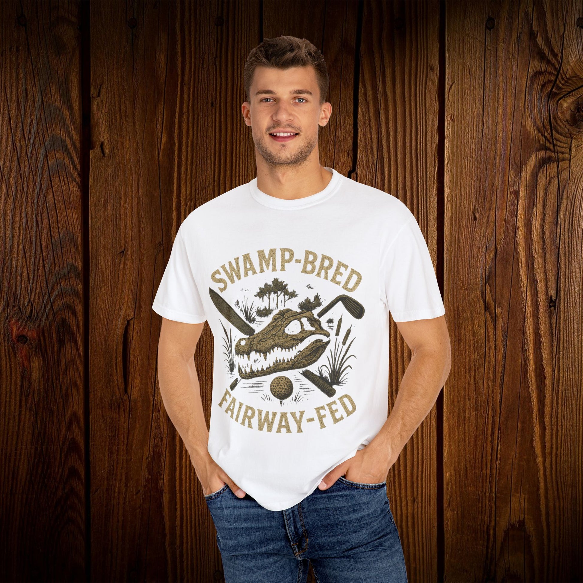 Model showcasing the Unisex Swamp-Bred Fairway-Fed Tee in white, emphasizing the eye-catching alligator graphic and relaxed fit for versatile styling.