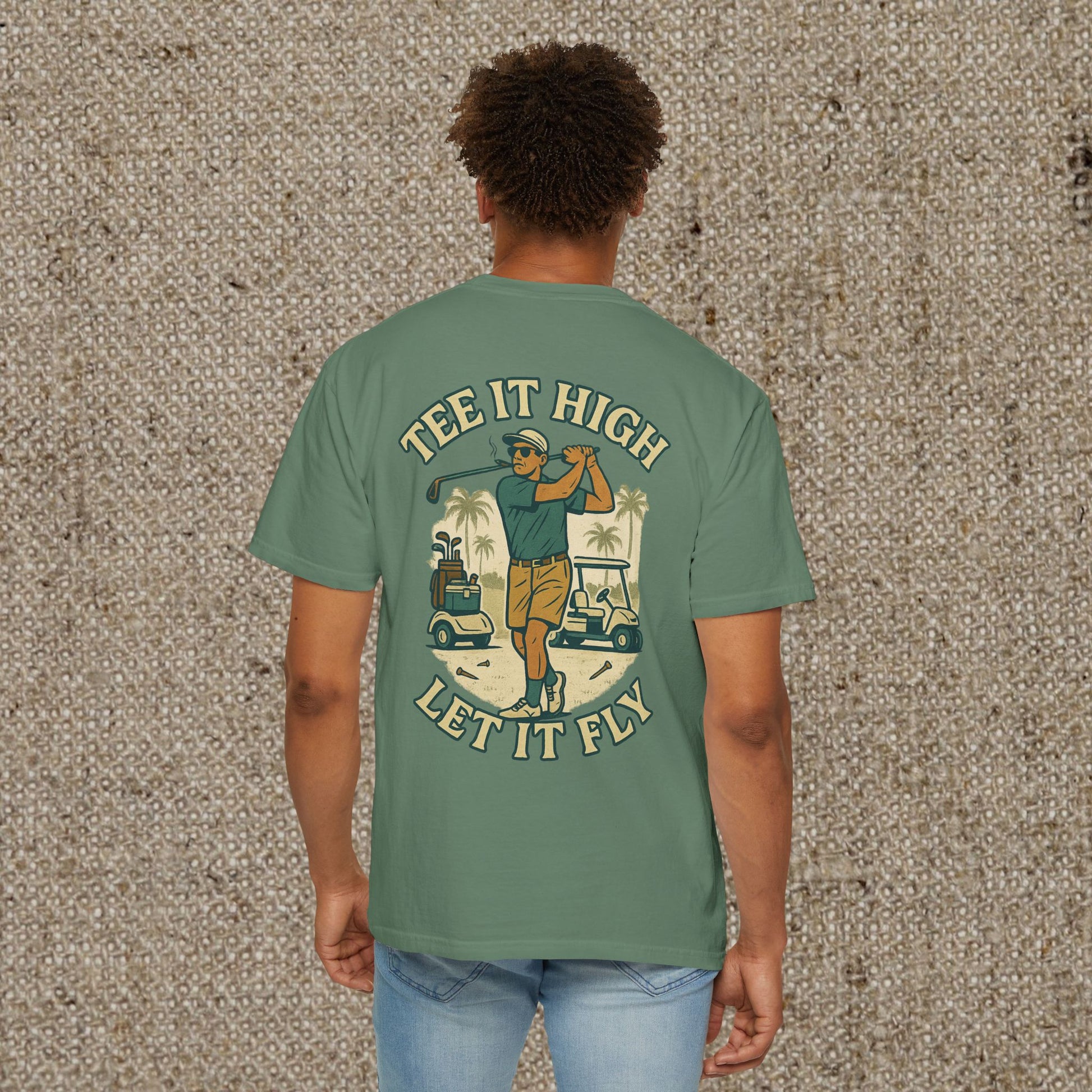 Back view of the 'Tee It High Let It Fly Graphic Tee' worn by a man, highlighting the golfer graphic, suitable for all occasions.