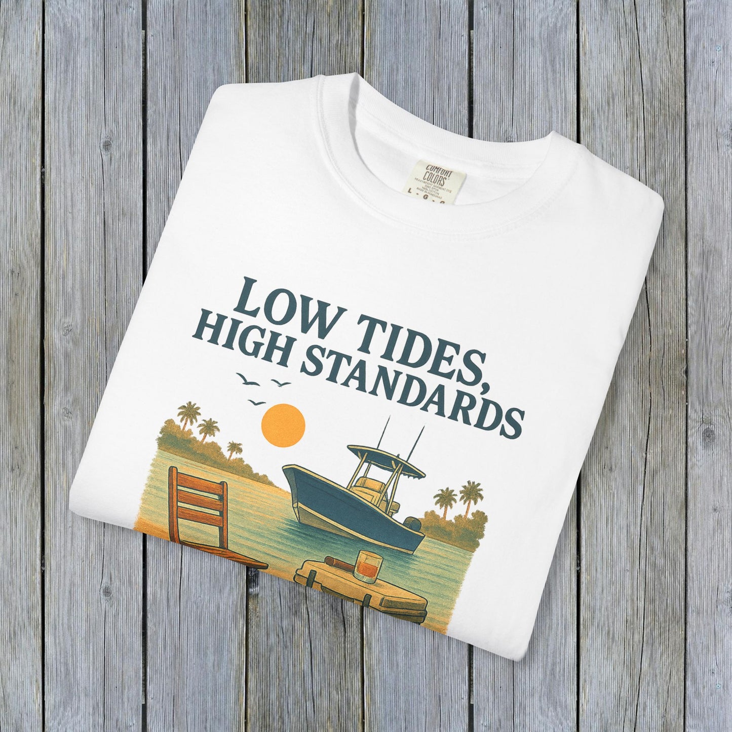 Flat lay of a white garment-dyed Low Tides High Standards T-Shirt featuring a colorful beach graphic, perfect for summer wear.