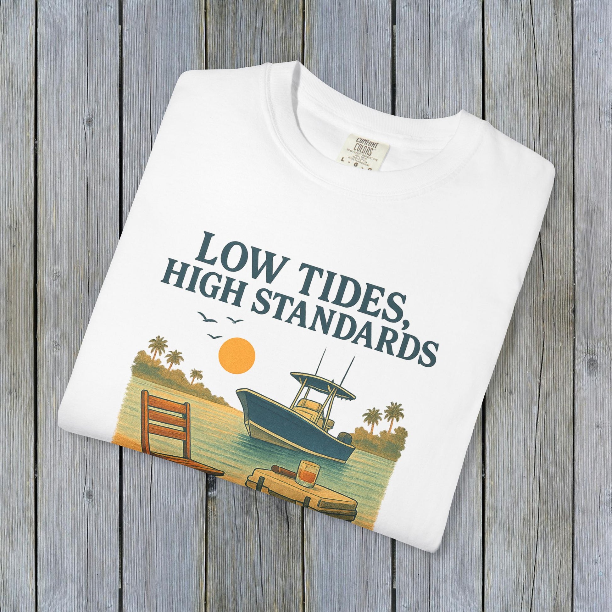 Flat lay of a white garment-dyed Low Tides High Standards T-Shirt featuring a colorful beach graphic, perfect for summer wear.