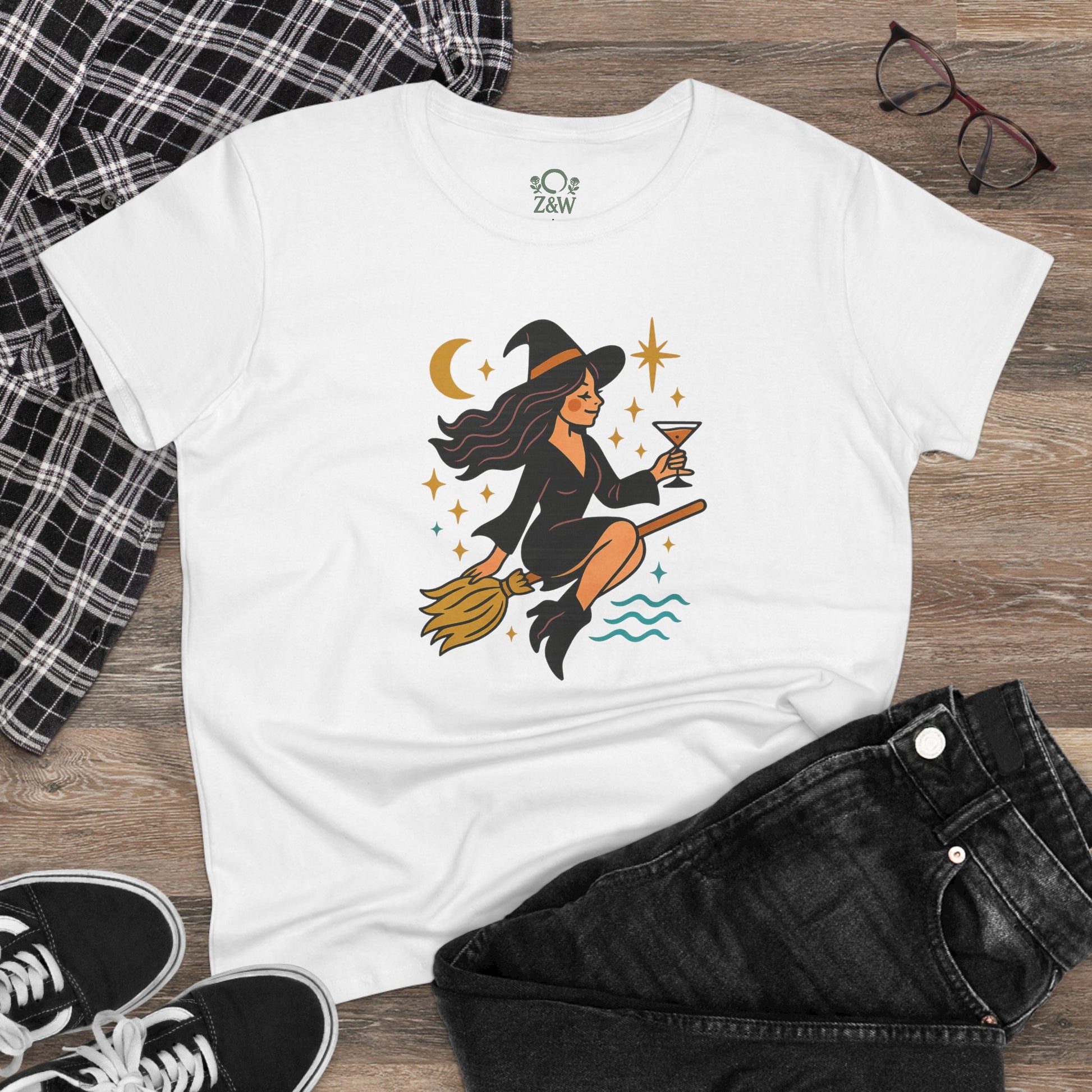Witchy Night Out Tee - Front view of a white t-shirt with a fun witch design, paired with casual wear, great for a chic and playful look.