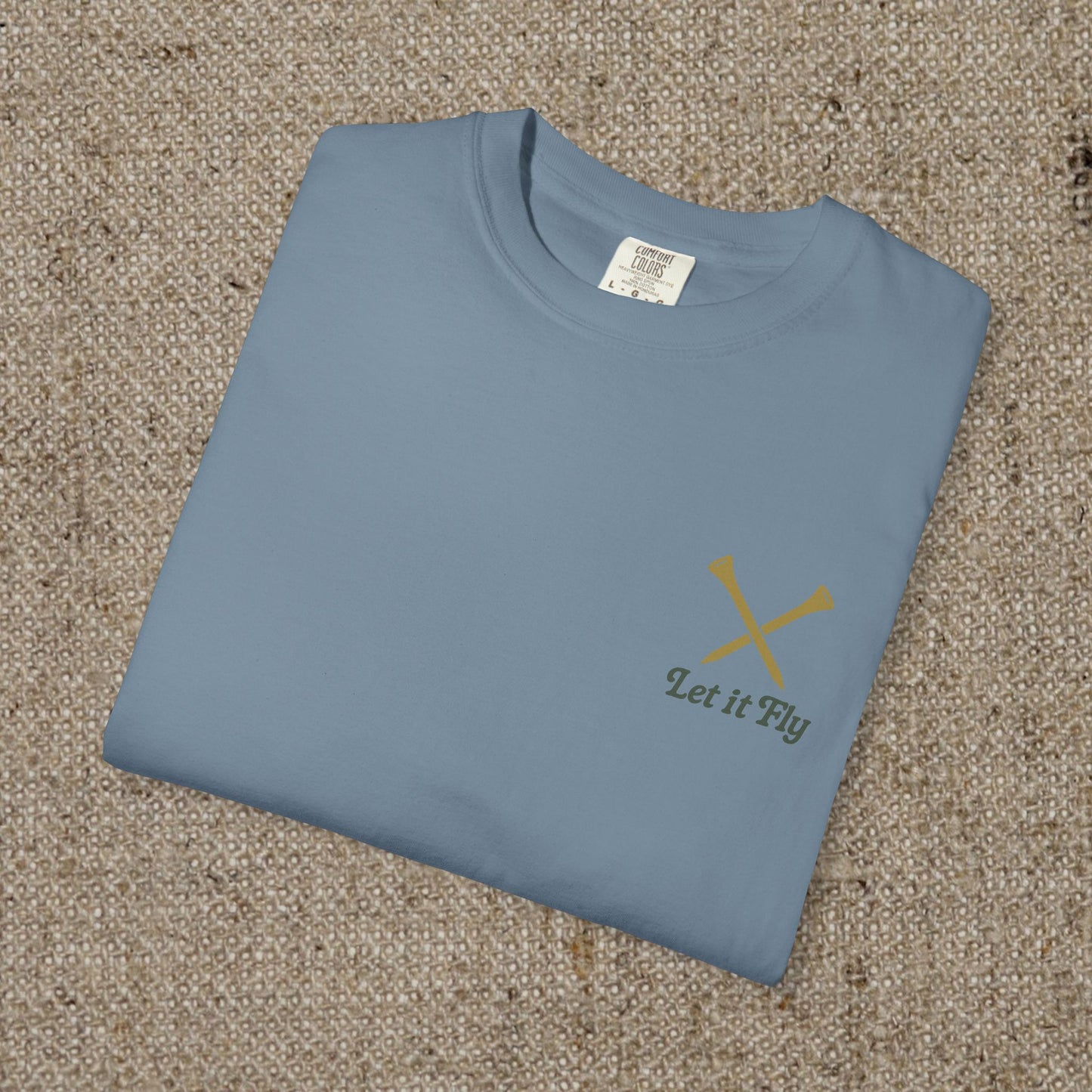 Folded Tee It High Let It Fly Graphic Tee in soft blue, highlighting a minimalist design with 'Let It Fly' text, made from ethically sourced US cotton.