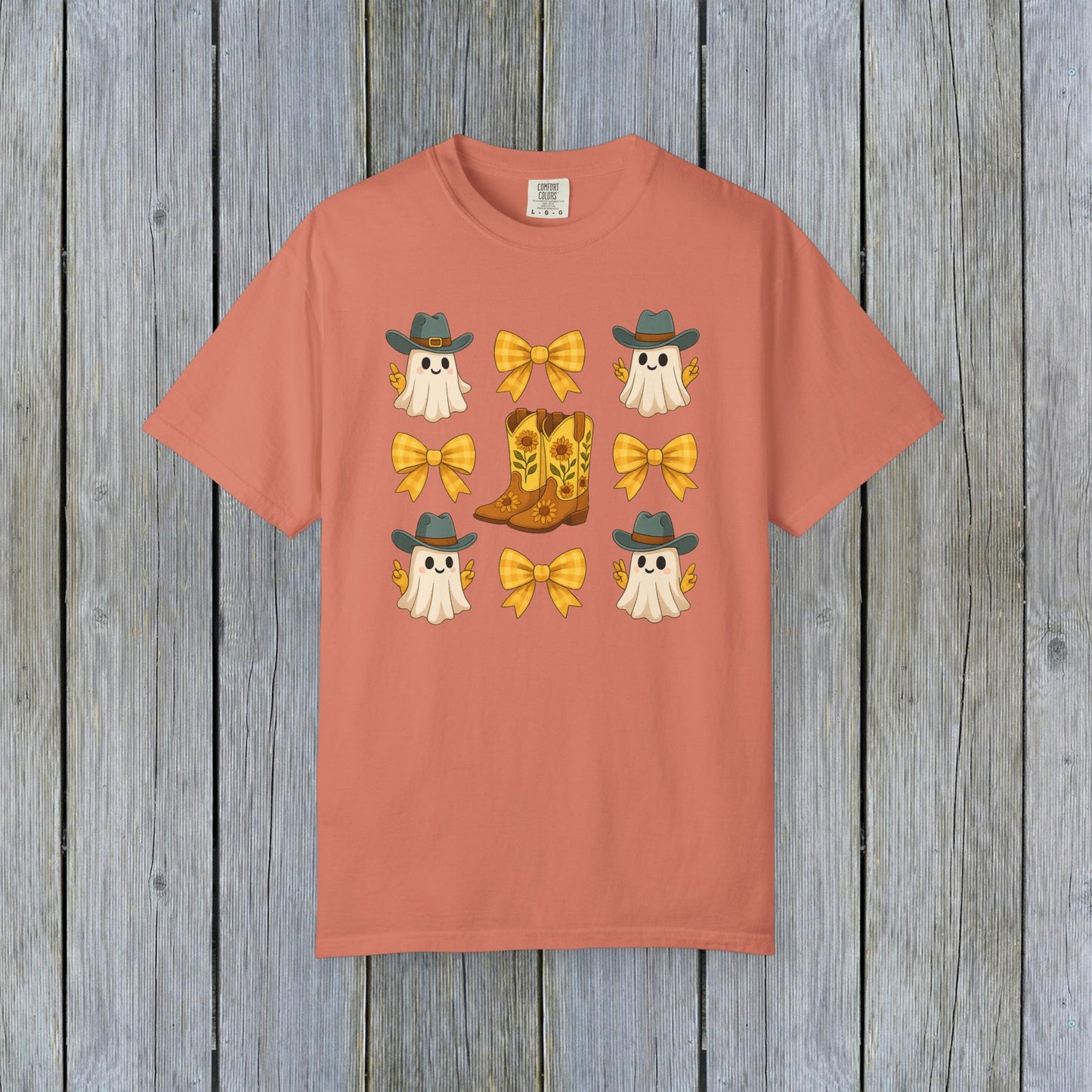 Cute Halloween T-Shirt highlighted by charming ghosts and cowboy boots, suitable for unisex fall fashion. Eco-friendly fabric makes it a sustainable choice for Halloween.