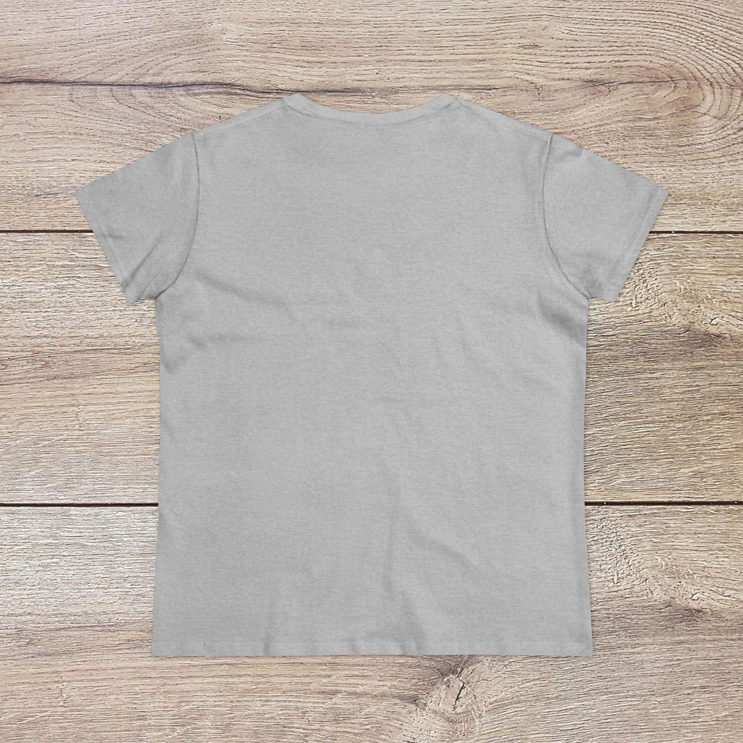 Back view of the Out Of Office Cruise Tee displayed on a wooden background, highlighting the simplicity and comfort of this soft cotton blend shirt, ideal for layering during warm weather.
