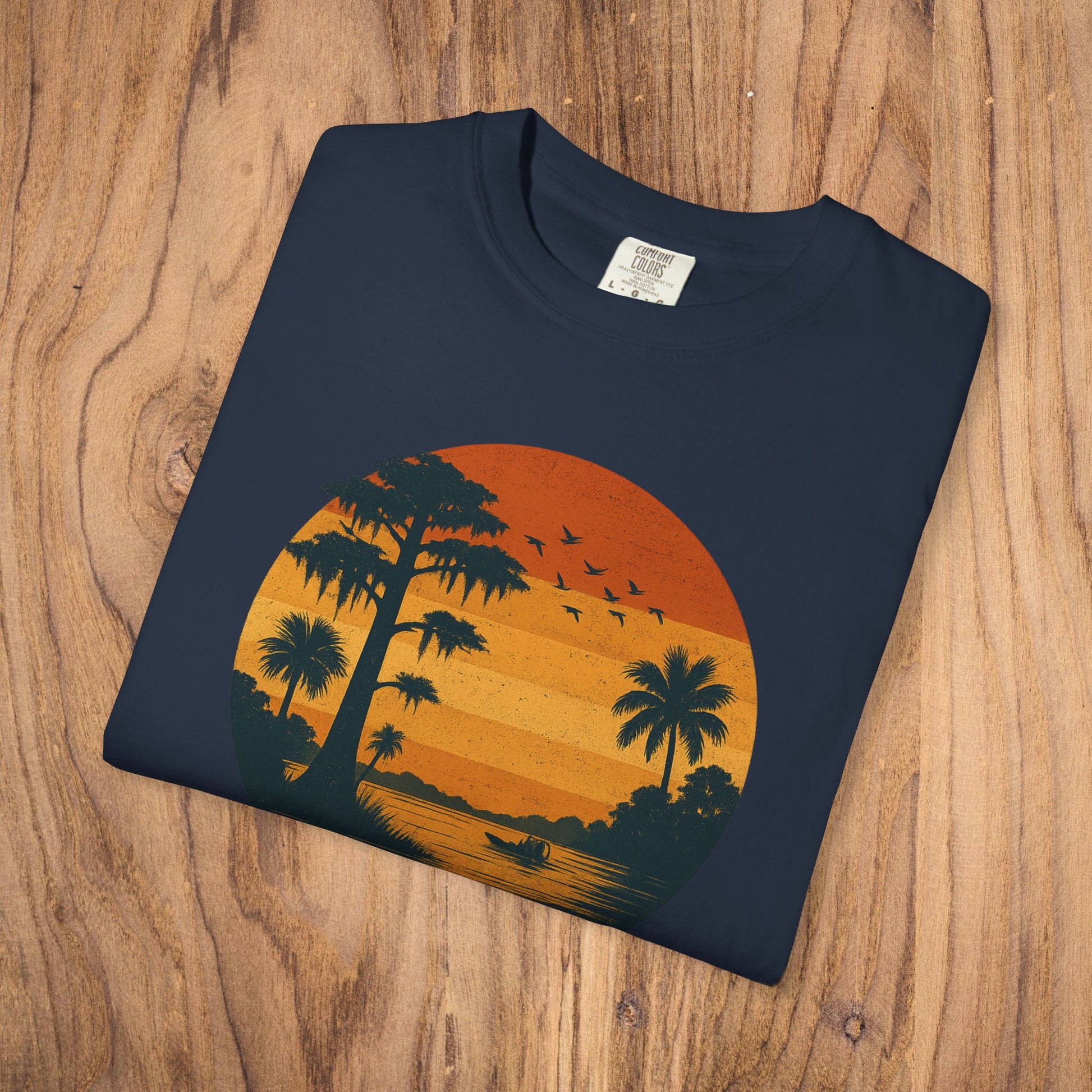 Unisex Garment-Dyed Sunset Tee featuring a sunset design with palm trees, available in sizes S to 4XL, perfect for casual wear.
