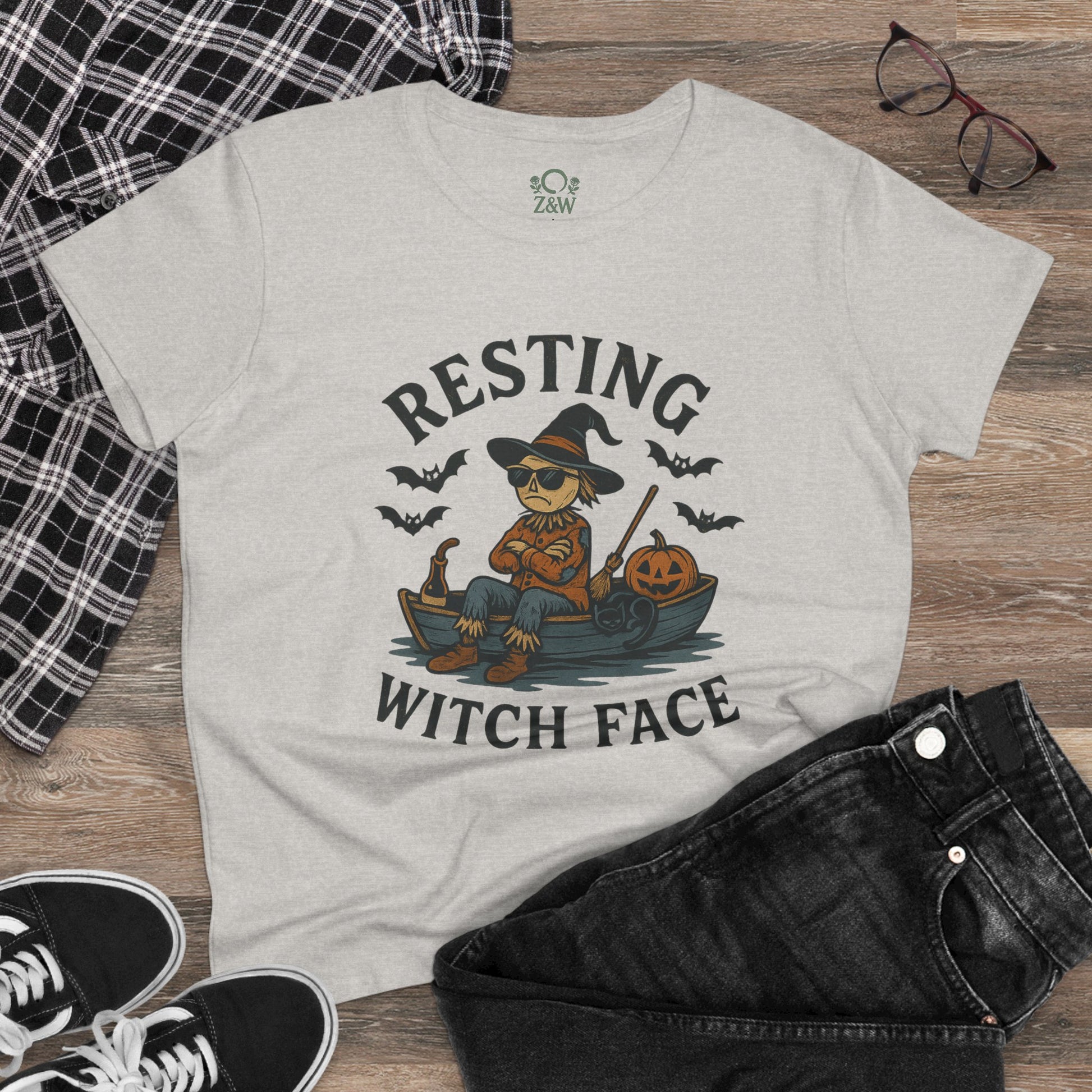 Resting Witch Face Halloween T-Shirt for Women featuring a playful scarecrow in a witch hat, perfect for parties and gifts. Stylish cotton tee in a light color, showcasing a fun Halloween theme.