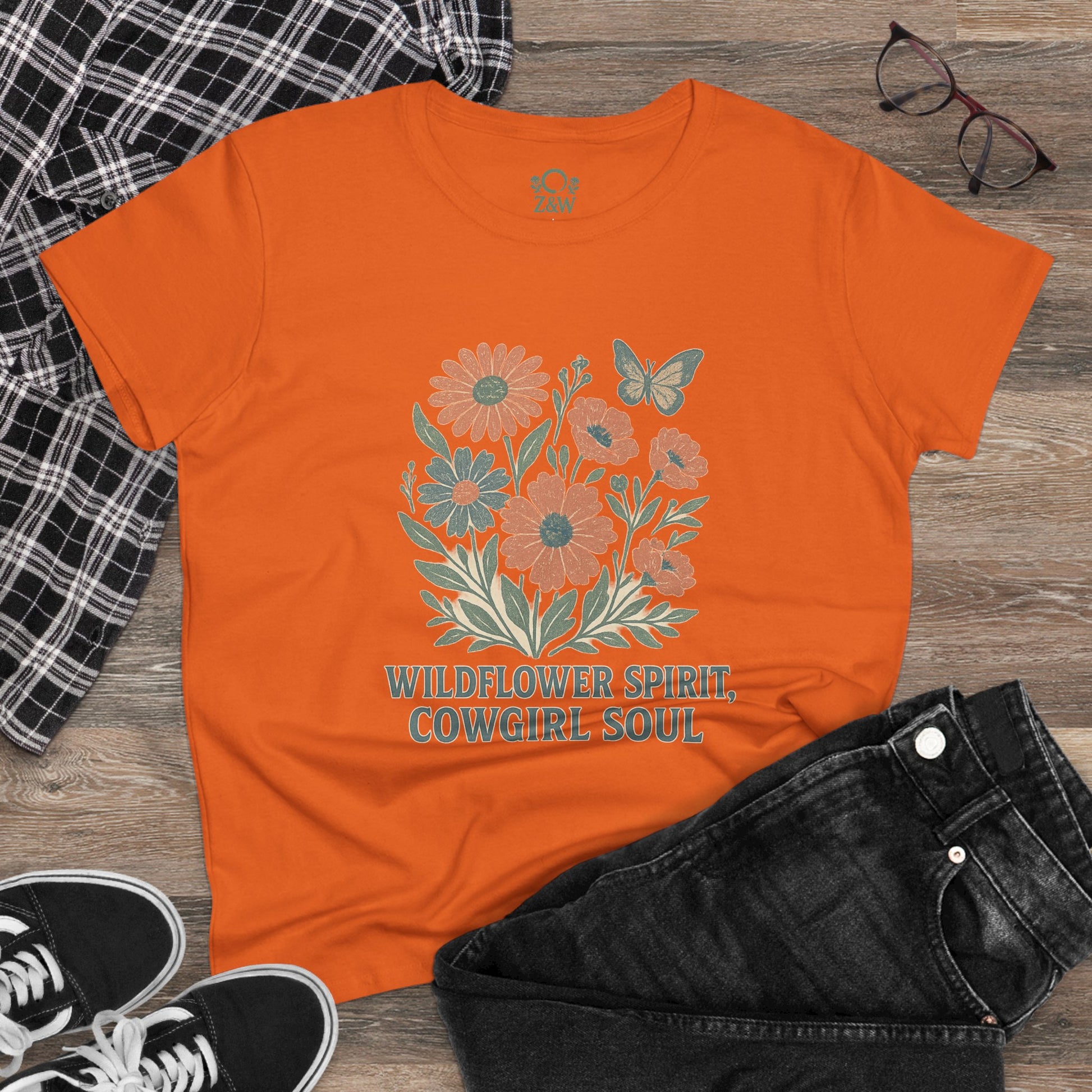 Wildflower Spirit Cotton Tee in orange, displaying a colorful flower and butterfly motif, offering a soft and comfortable fit.