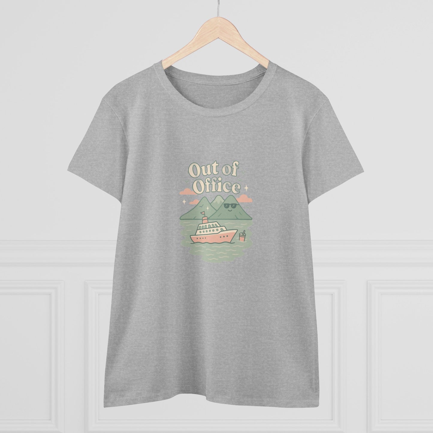Front view of the Out Of Office Cruise Tee hanging against a plain backdrop, featuring a whimsical cruise ship and mountain design, emphasizing its lightweight and comfortable design perfect for summer outfits.