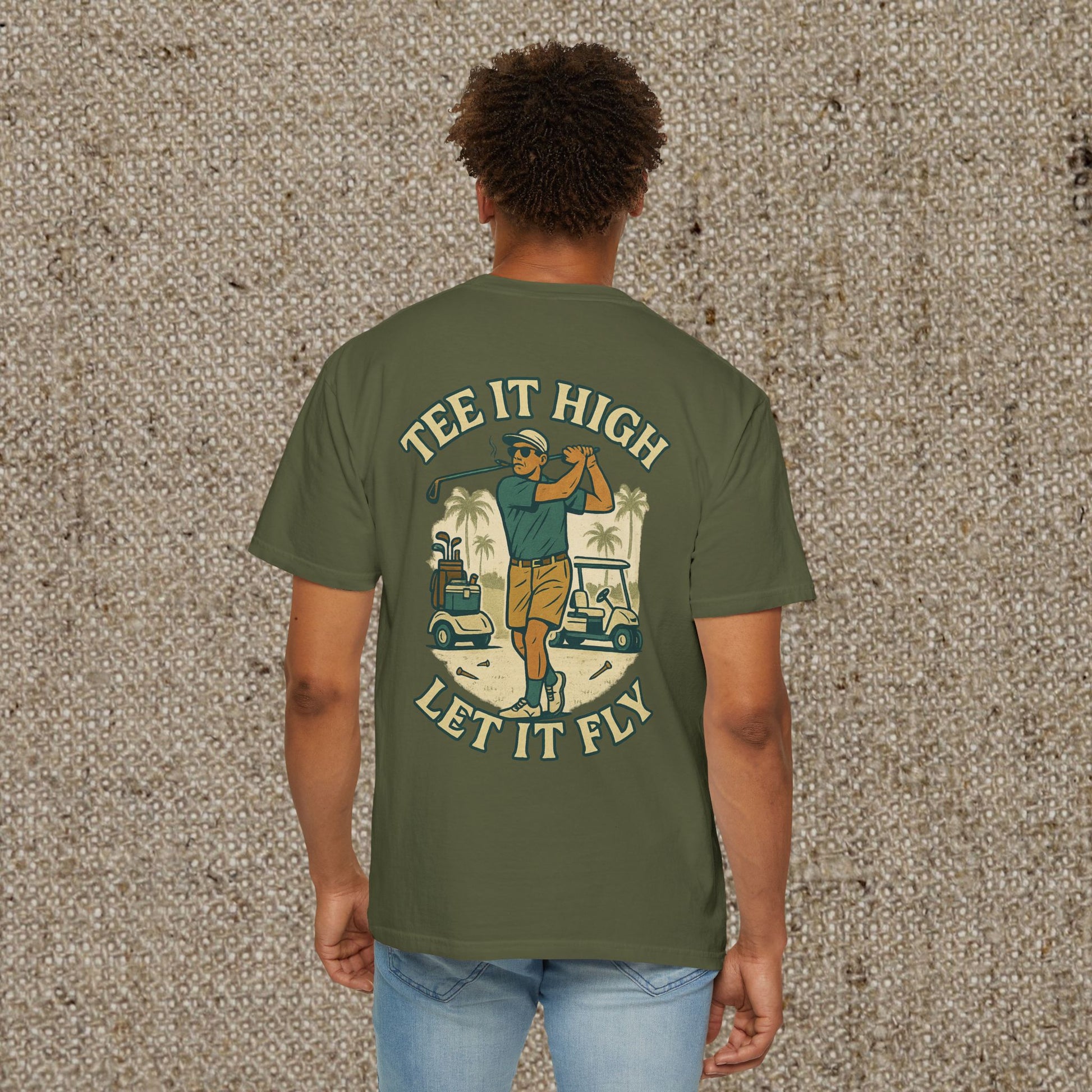 Back view of a male model in Tee It High Let It Fly Graphic Tee featuring an exciting golf scene, perfect for golf lovers.